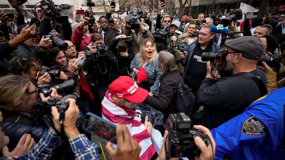 Trump supporters and opponents engage in a small-scale confrontation before a significant court hearing.