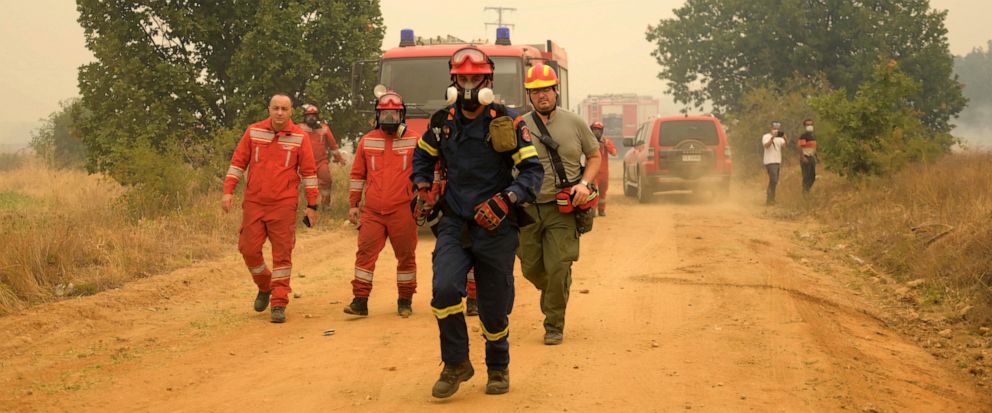 Firefighters successfully rescue 25 migrants trapped in forest amidst imminent threat of a massive wildfire in Greece