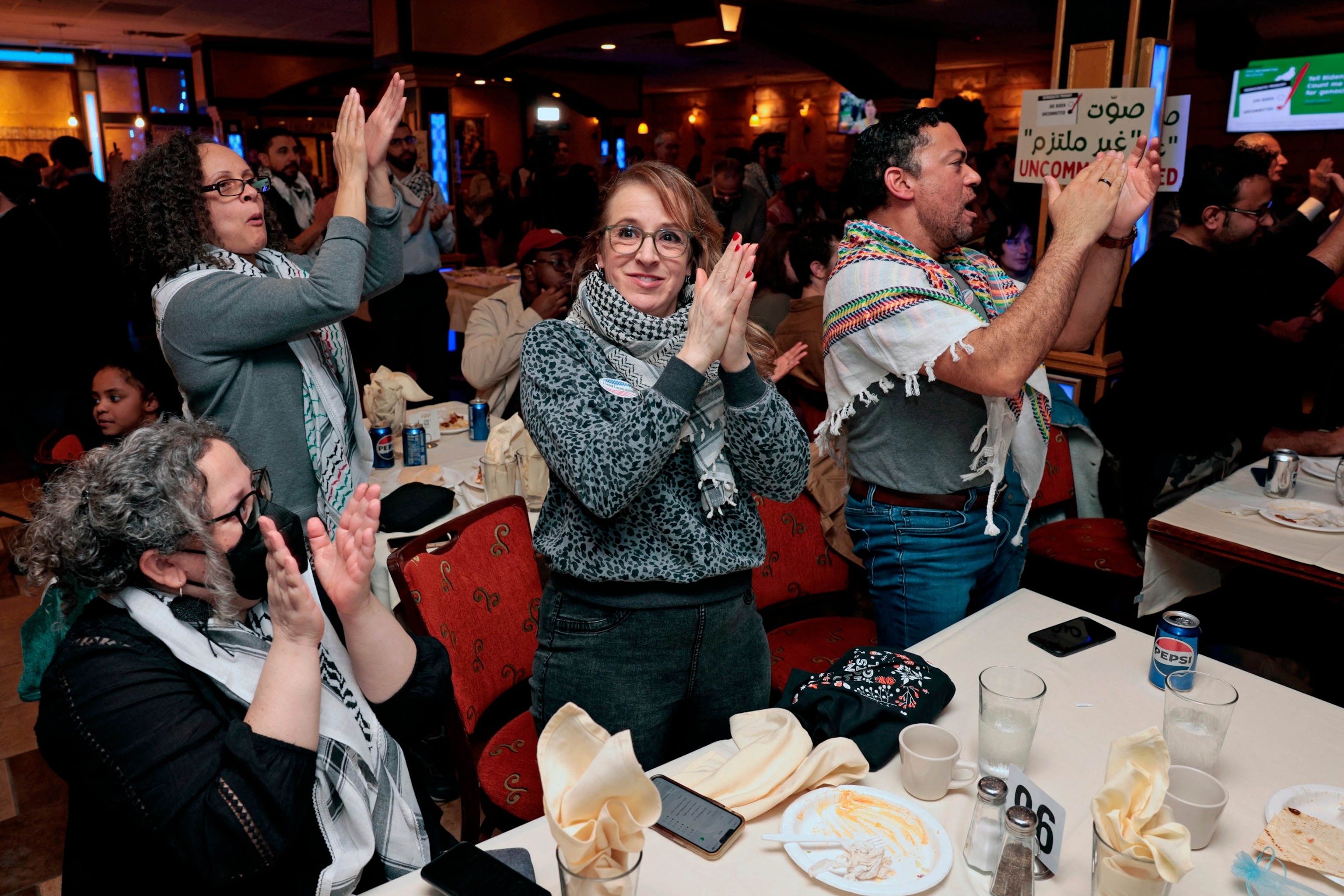 PHOTO: People cheer for preliminary election results at the People hug at the Listen to Michigan watch party, a group who asked voters to vote uncommitted instead of for President Joe Biden in Michigan's primary election, in Dearborn, Mi., Feb. 27, 2024. 