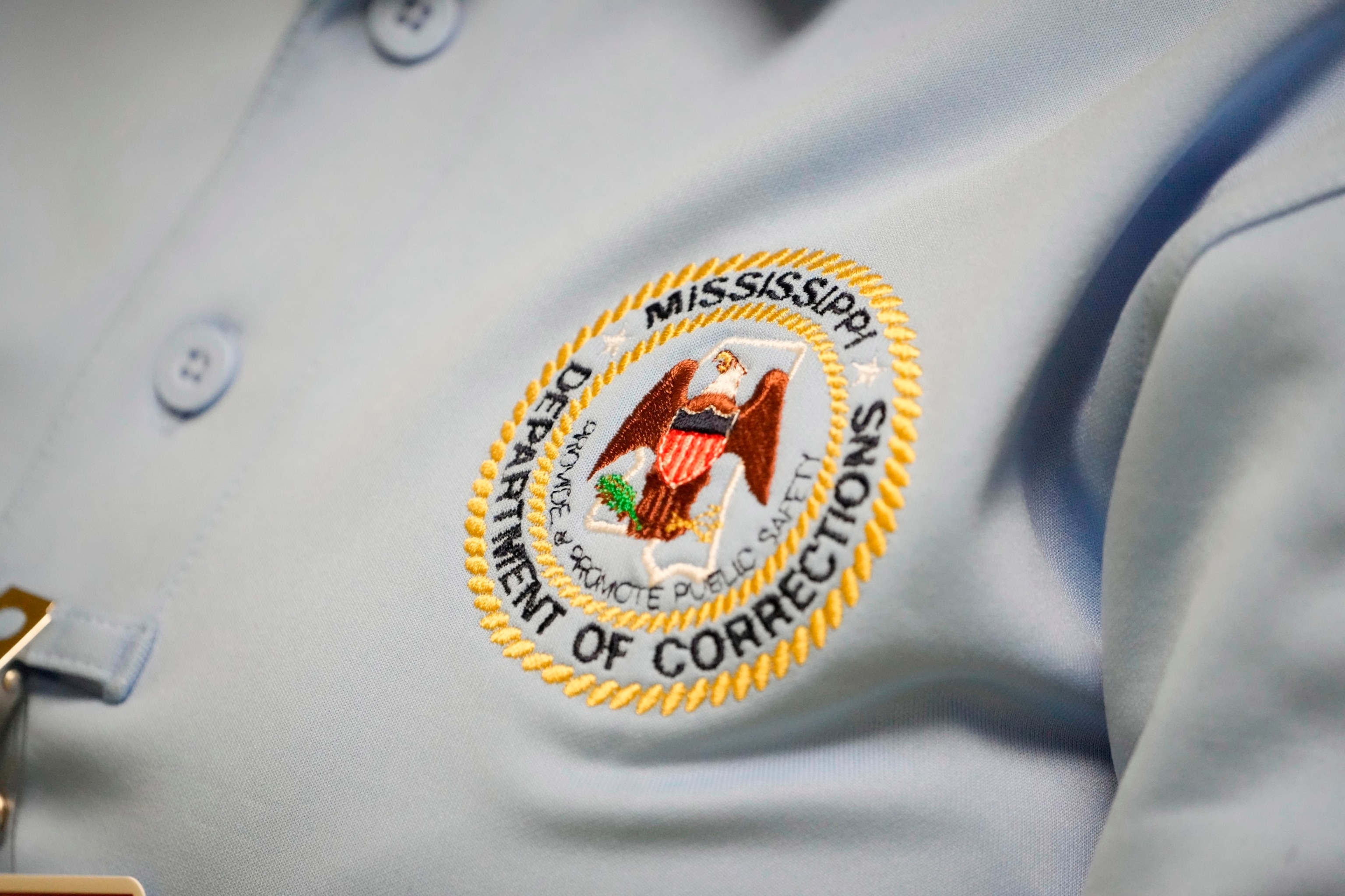 PHOTO: The logo of the Mississippi Department of Corrections is shown on the shirt of a corrections officer, May 9, 2023, at Central Mississippi Correctional Facility in Pearl, Miss. 