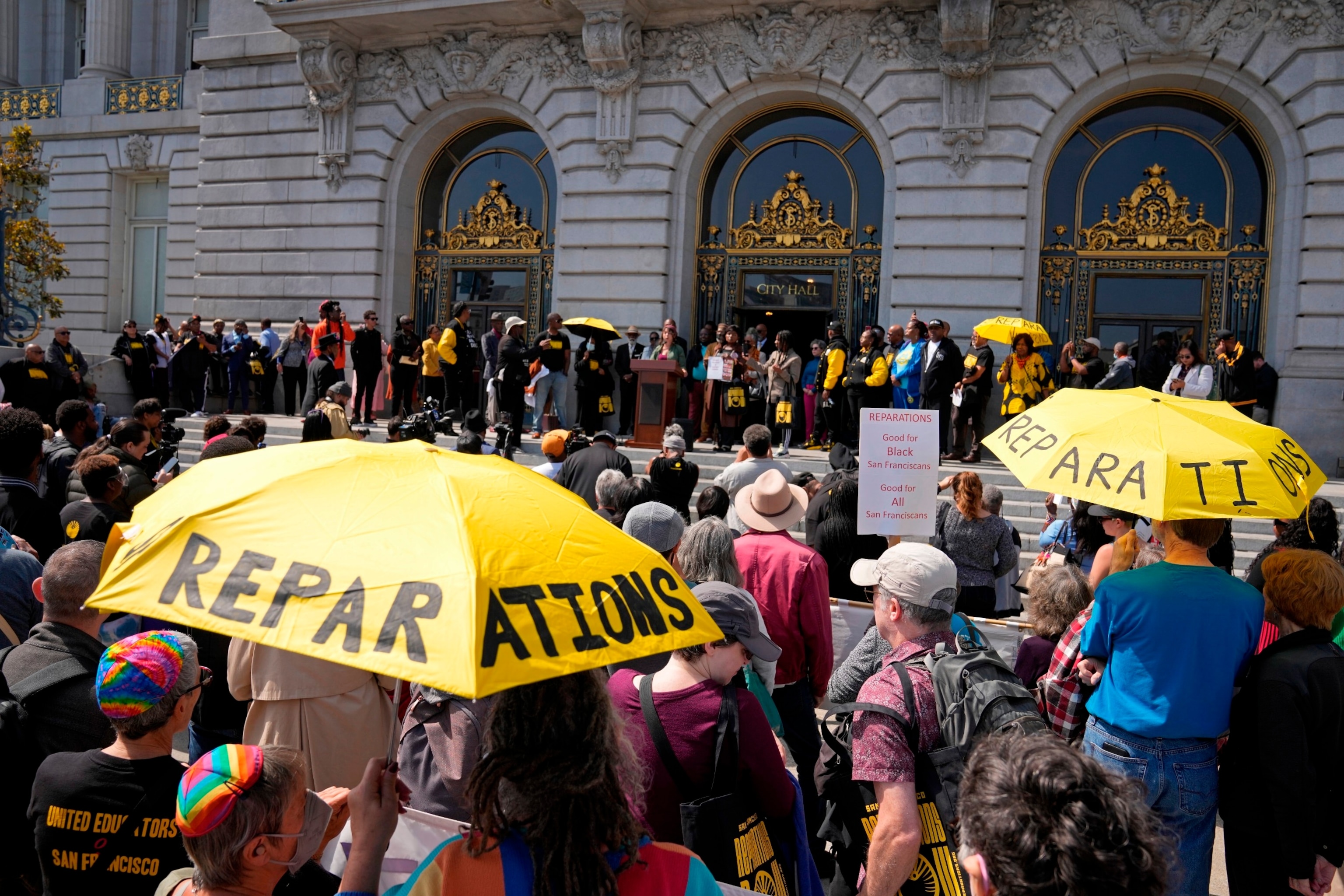 PHOTO: People listen during a rally in support of reparations for African Americans outside City Hall in San Francisco, Sept. 19, 2023.  