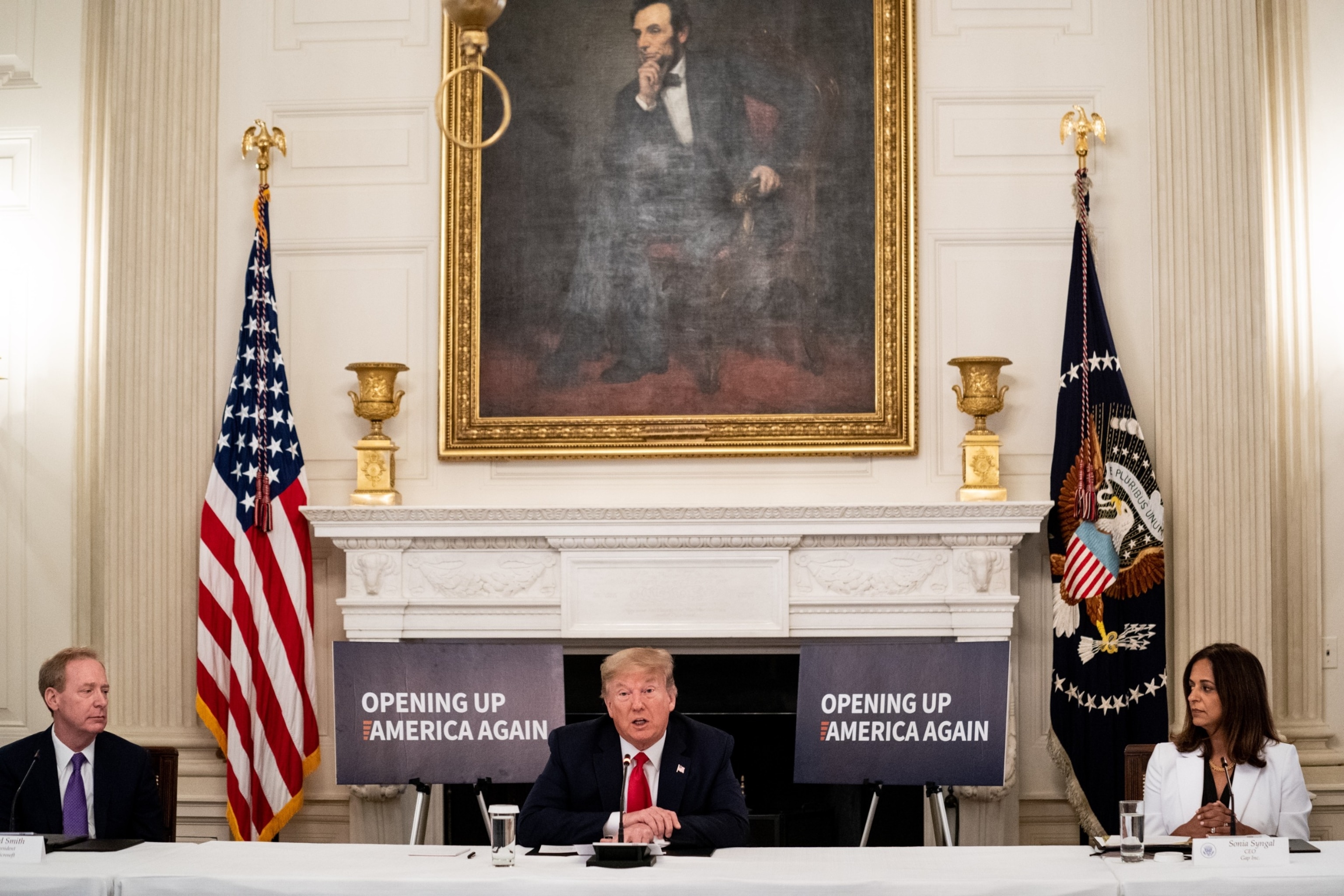PHOTO: Brad Smith, president of Microsoft Corp., left, and Sonia Syngal, chief executive officer of Gap Inc., right, listen as President Donald Trump speaks during a meeting, May 29, 2020. 