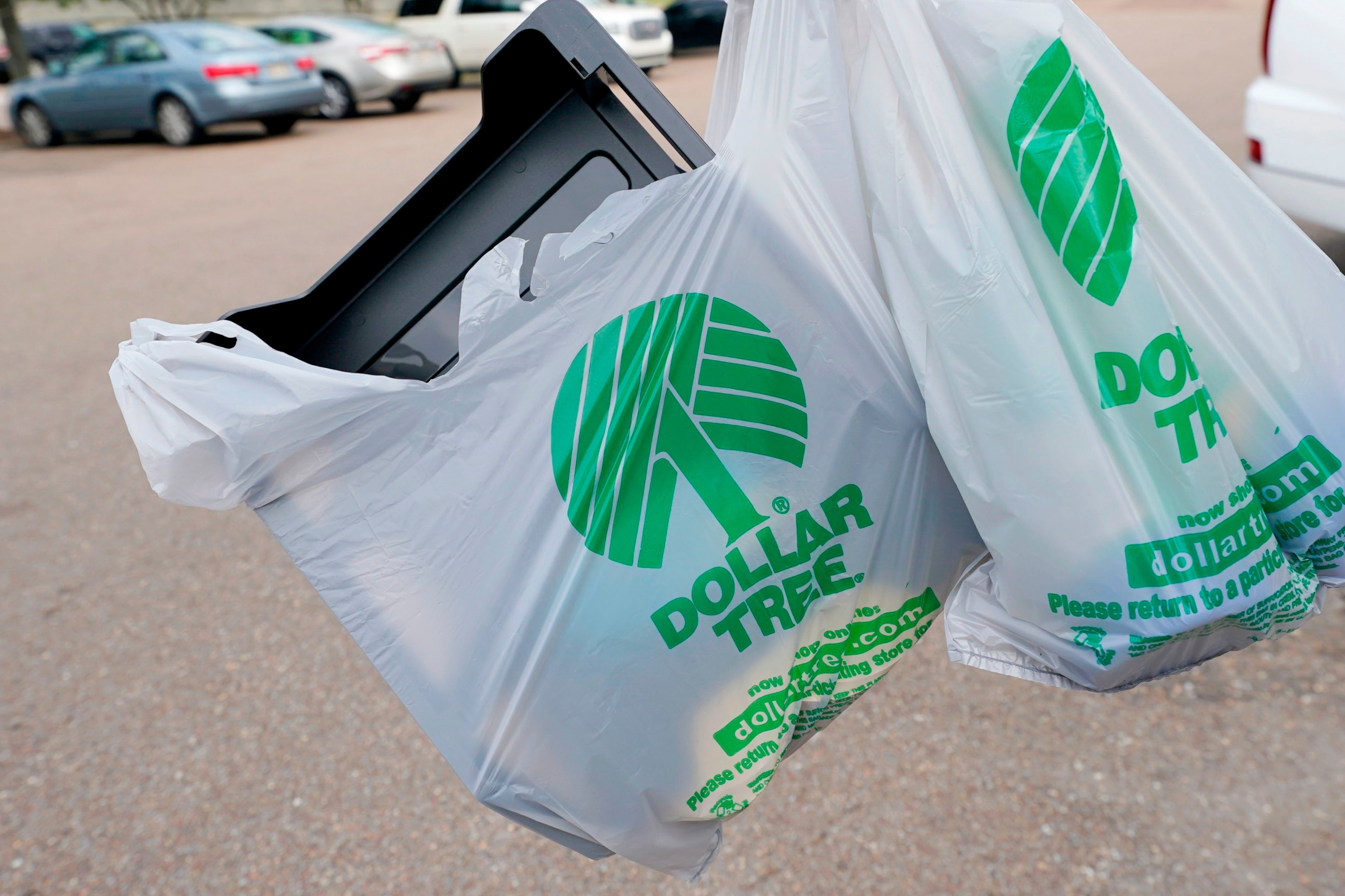 PHOTO: A customer exits a Dollar Tree store holding a shopping bag, May 11, 2022, in Jackson, Miss.