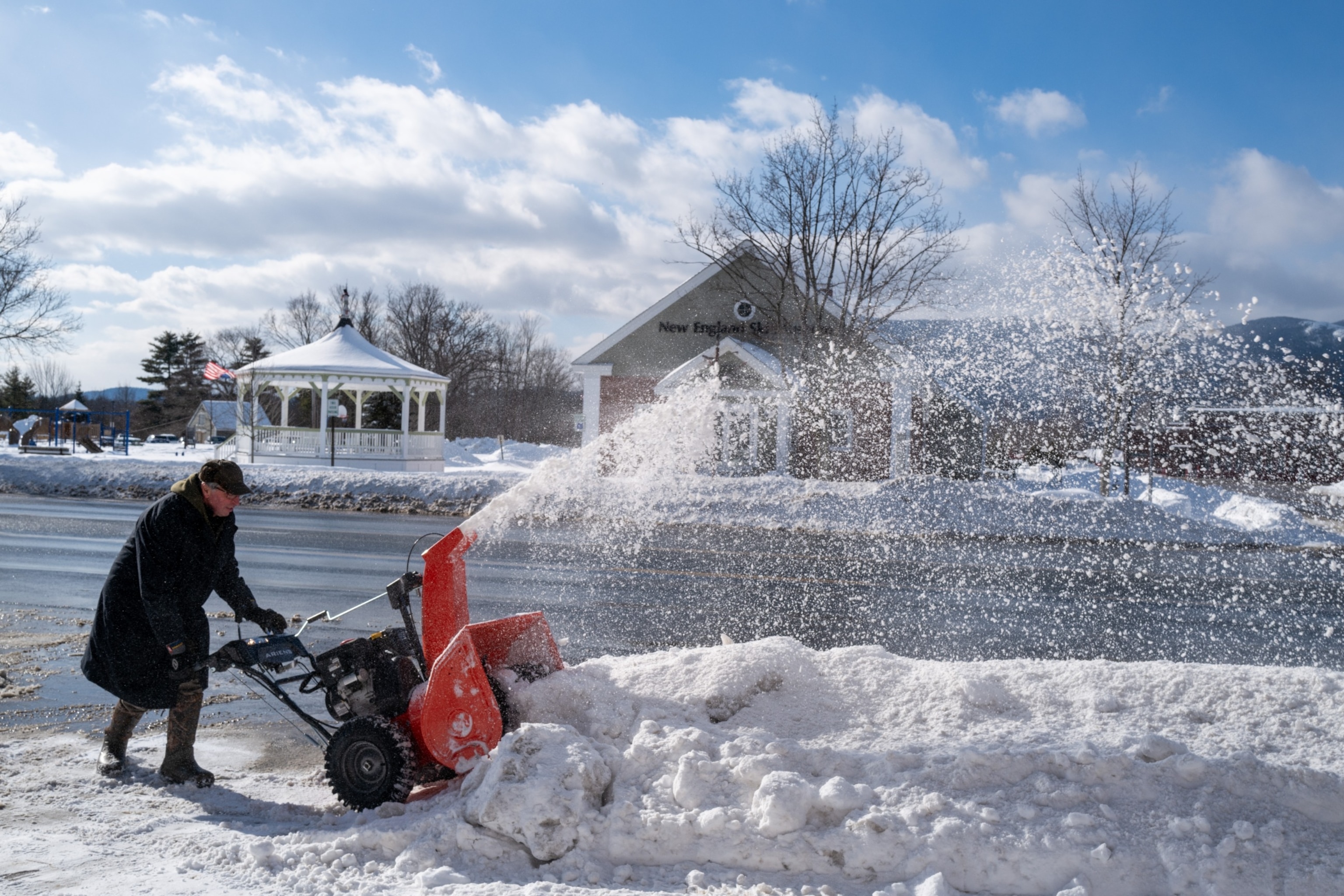 PHOTO: A man clears snow from a sidewalk on January 17, 2024 in North Conway, N.H.