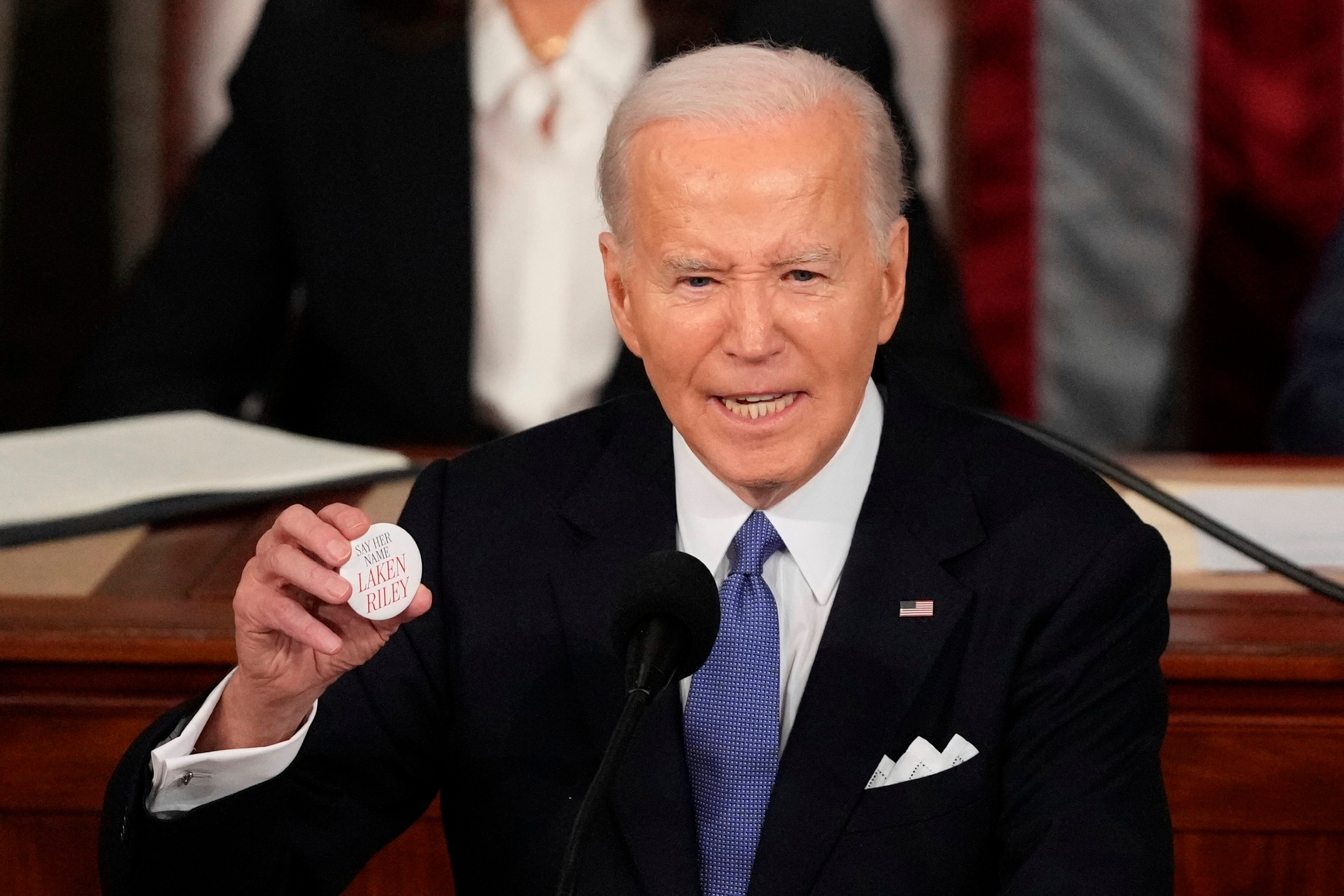 PHOTO: President Joe Biden holds up a Laken Riley button as he delivers the State of the Union address to a joint session of Congress at the U.S. Capitol, Mar. 7, 2024, in Washington. 