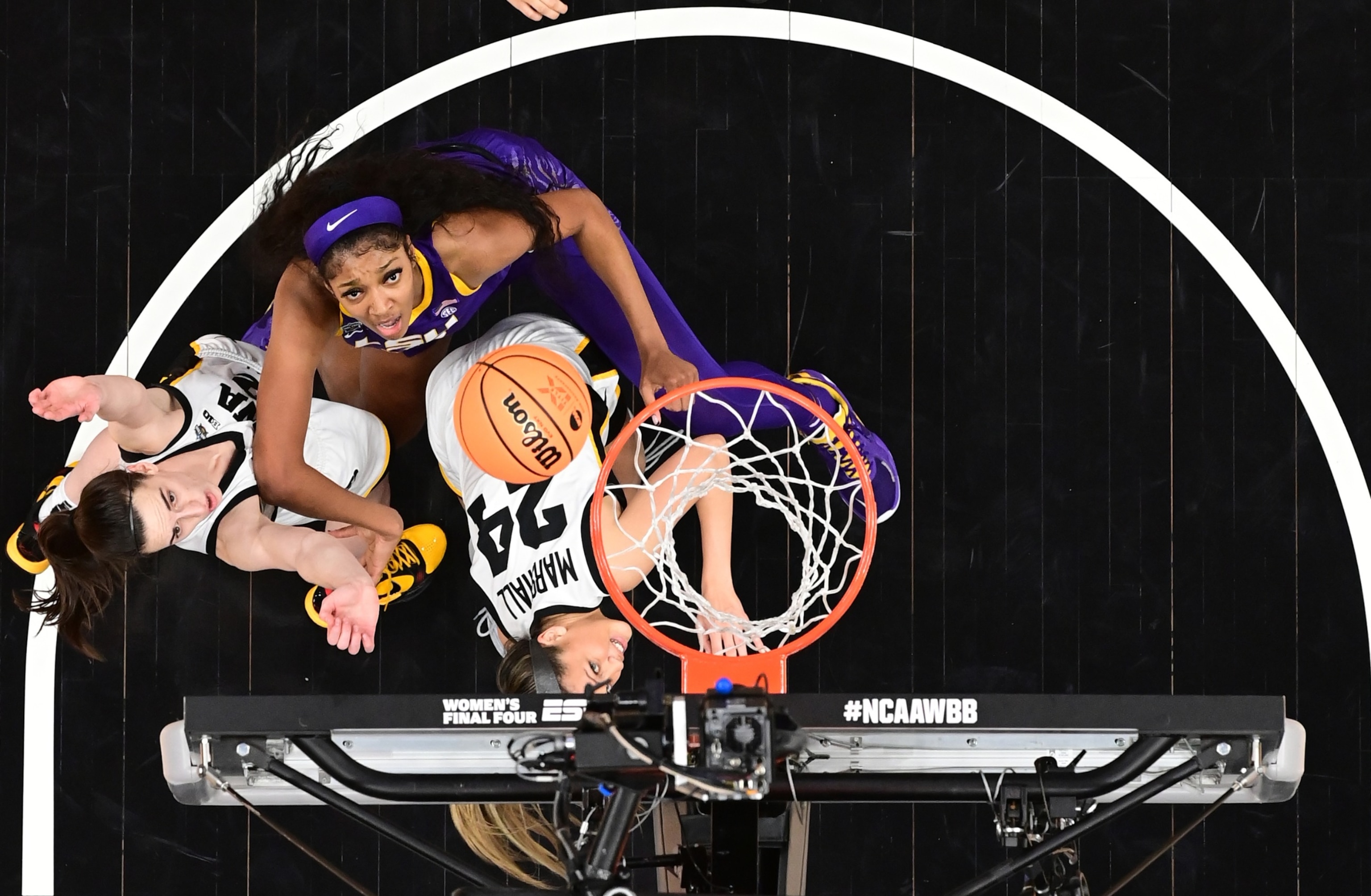PHOTO: In this April 2, 2023, file photo, Angel Reese of the LSU Lady Tigers and Caitlin Clark and Gabbie Marshall of the Iowa Hawkeyes are shown during the 2023 NCAA Women's Basketball Tournament National Championship, in Dallas, Texas. 