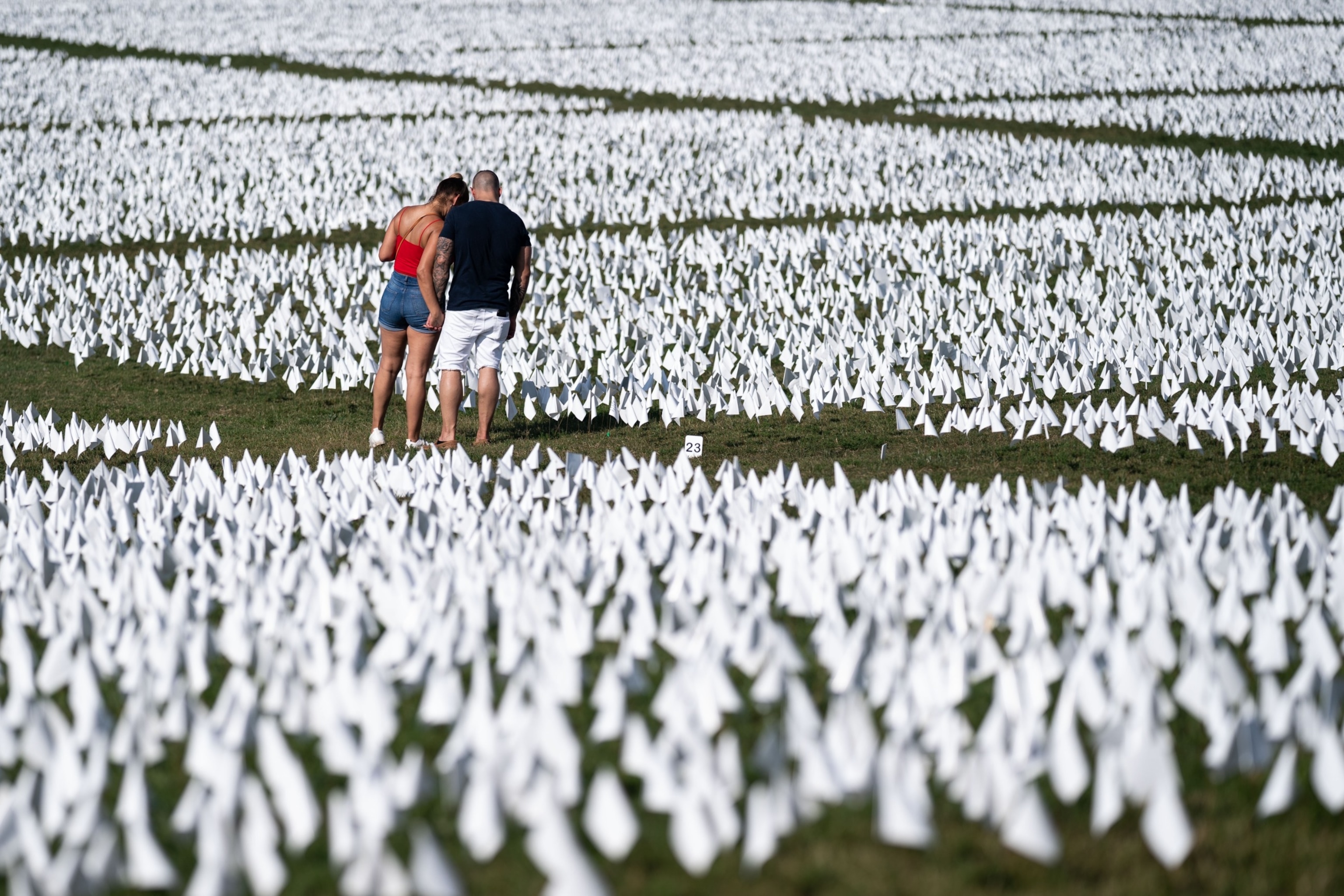 PHOTO: People visit the 'In America: Remember' public art installation near the Washington Monument on the National Mall, Sept. 18, 2021, in Washington, D.C. 