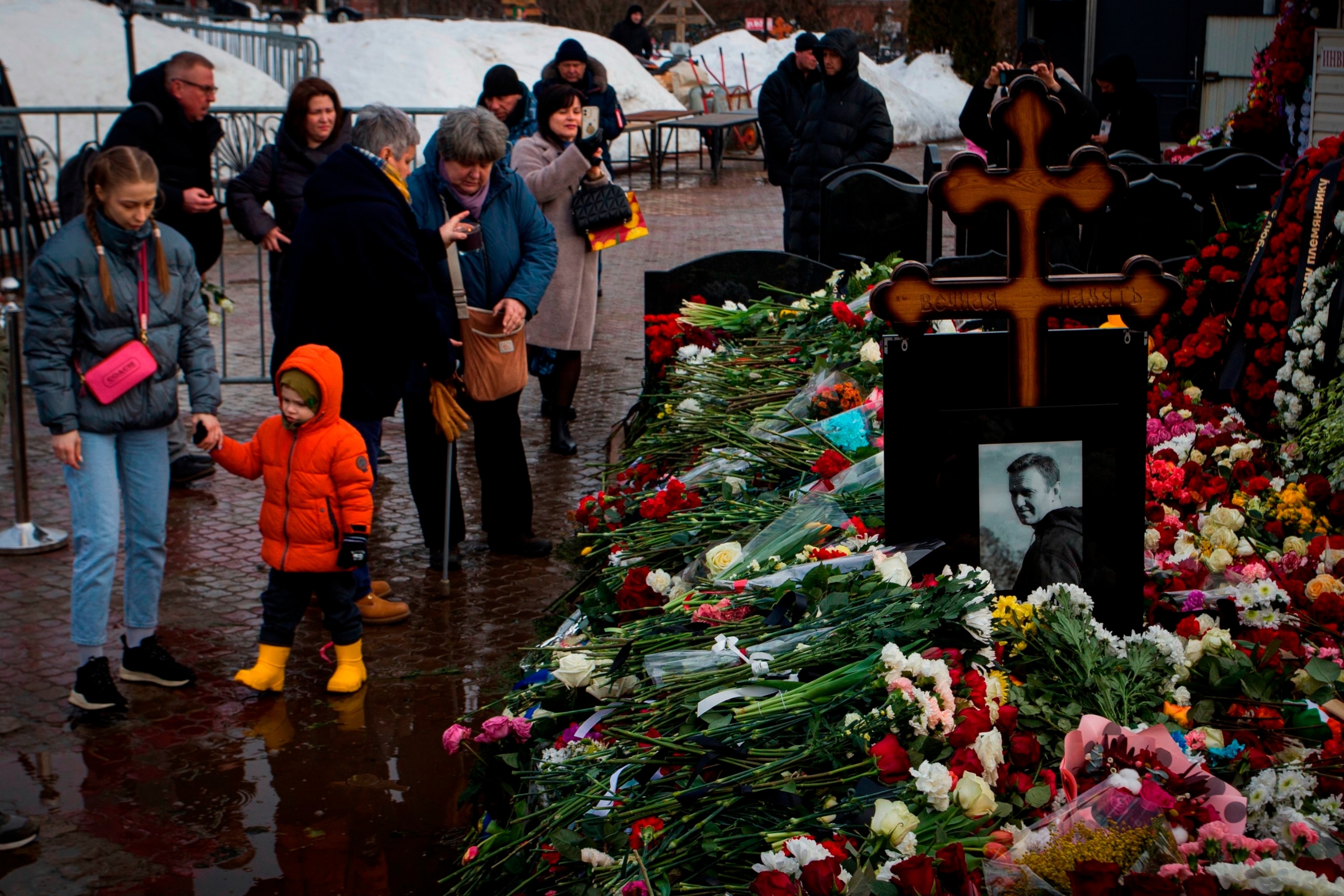 PHOTO: People lay flowers at the grave of Russian opposition leader Alexei Navalny to honor his memory at the Borisov Cemetery in Moscow.