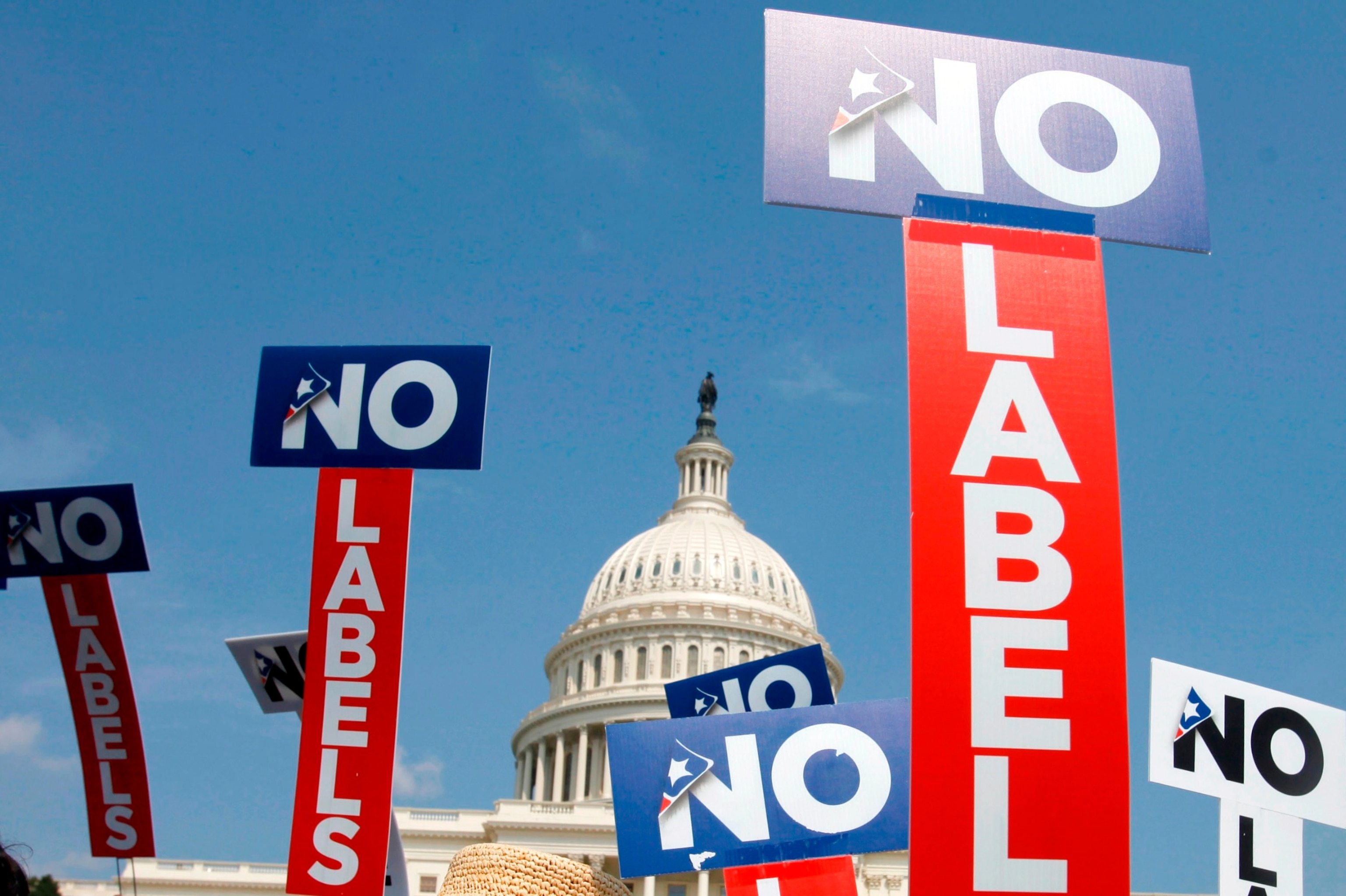 PHOTO: People with the group No Labels hold signs during a rally on Capitol Hill, July 13, 2013. 