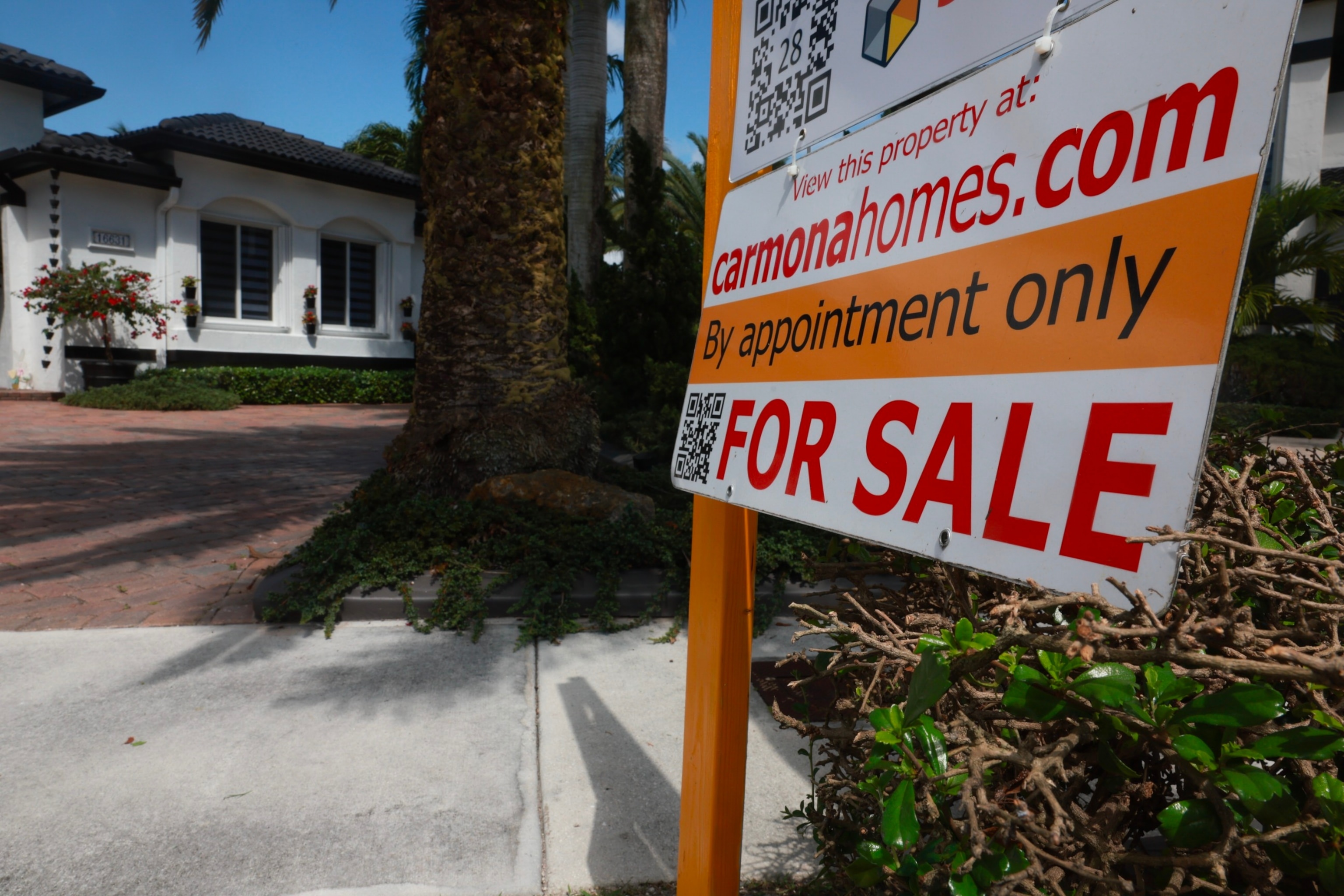 PHOTO: A 'For Sale' sign is posted on the lawn in front of a home on March 15, 2024, in Miami, Florida.