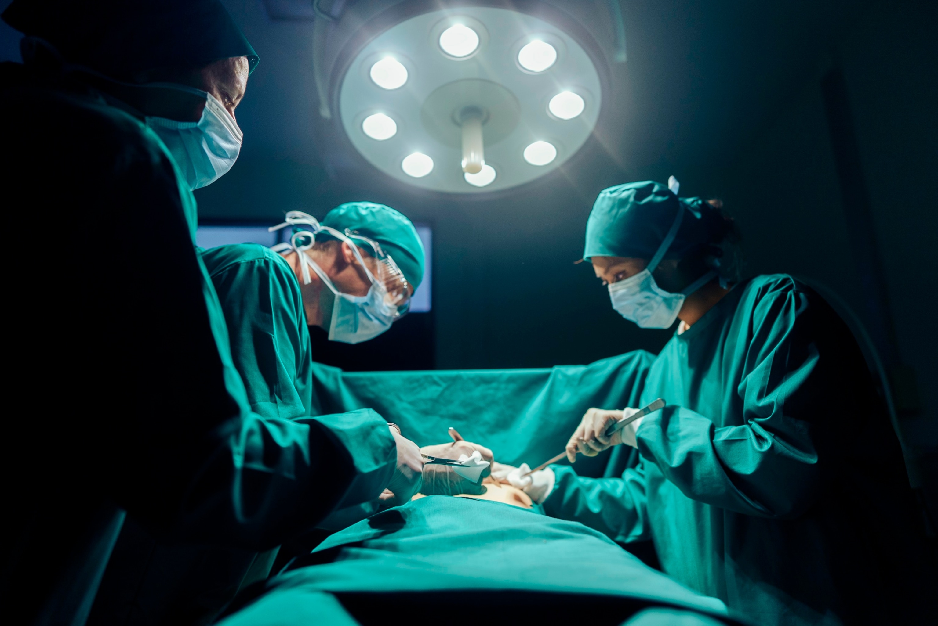 PHOTO: In this undated stock photo, three surgeons perform an operating on a patient.