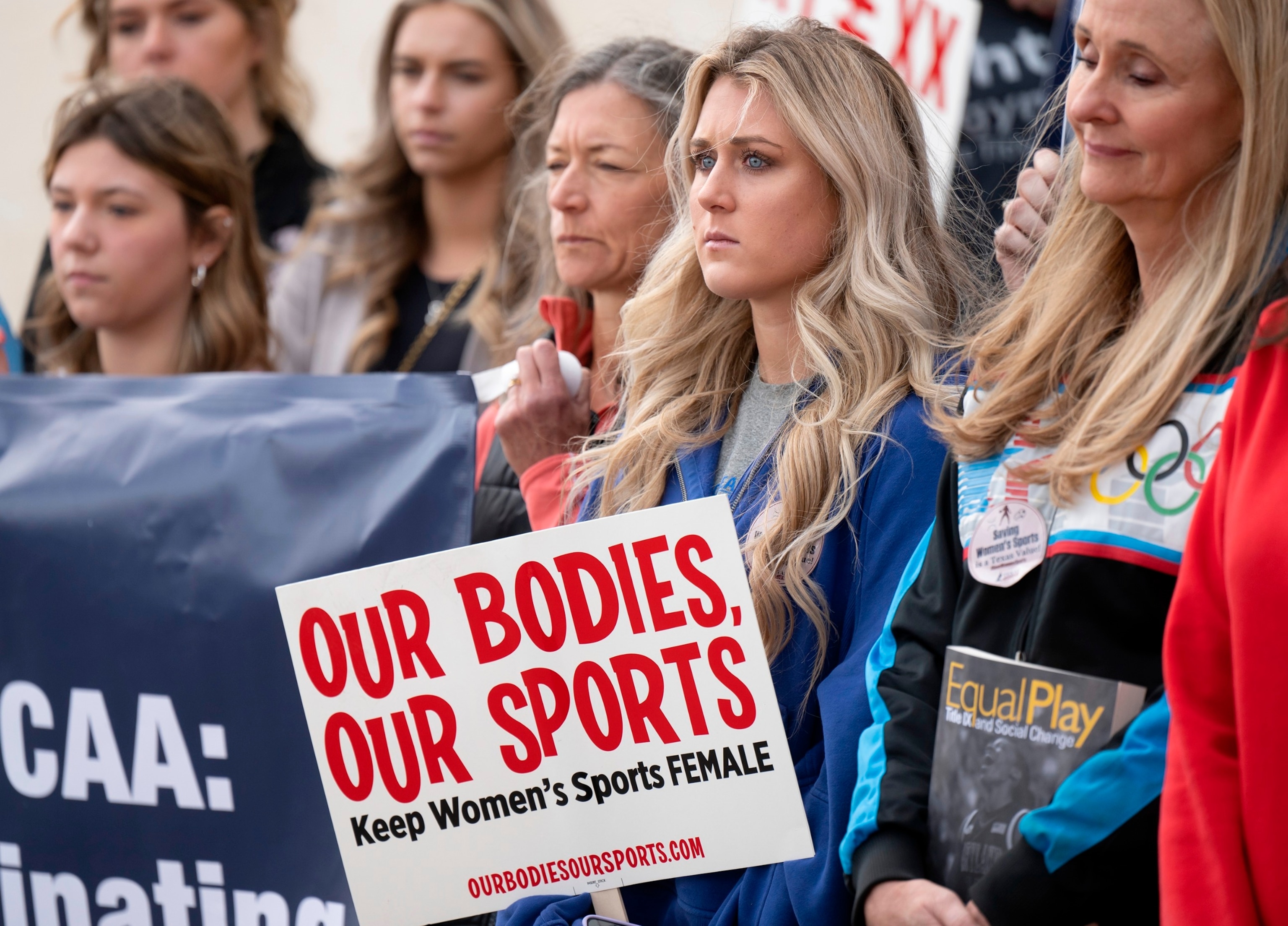 PHOTO: In this Jan. 12, 2023, file photo, former University of Kentucky swimmer Riley Gaines, second from right, stands during a rally outside of the NCAA Convention in San Antonio, Texas.