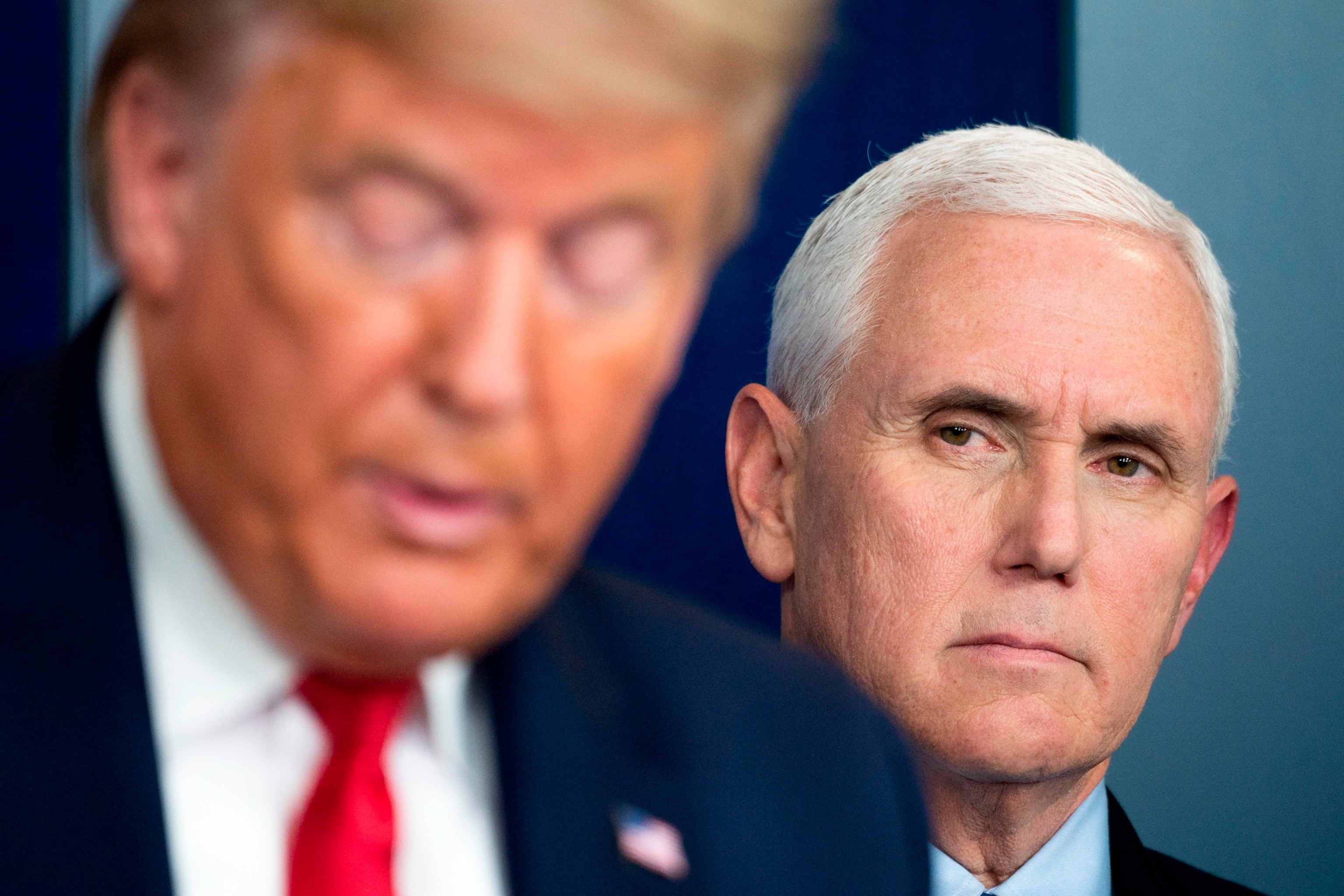 PHOTO: Vice President Mike Pence listens as President Donald Trump speaks during a press briefing at the White House in Washington, DC, on March 26, 2020.