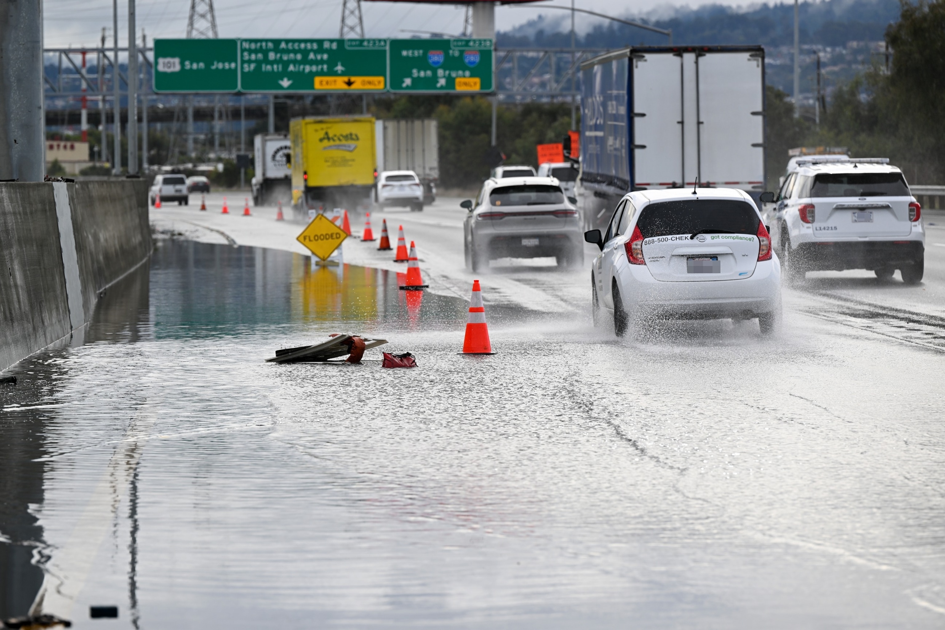 PHOTO: IN this Dec. 20, 2023, file photo, the left lane is closed as cars commute on Highway 101 near the San Francisco International Airport (SFO) as heavy rain hits San Francisco.