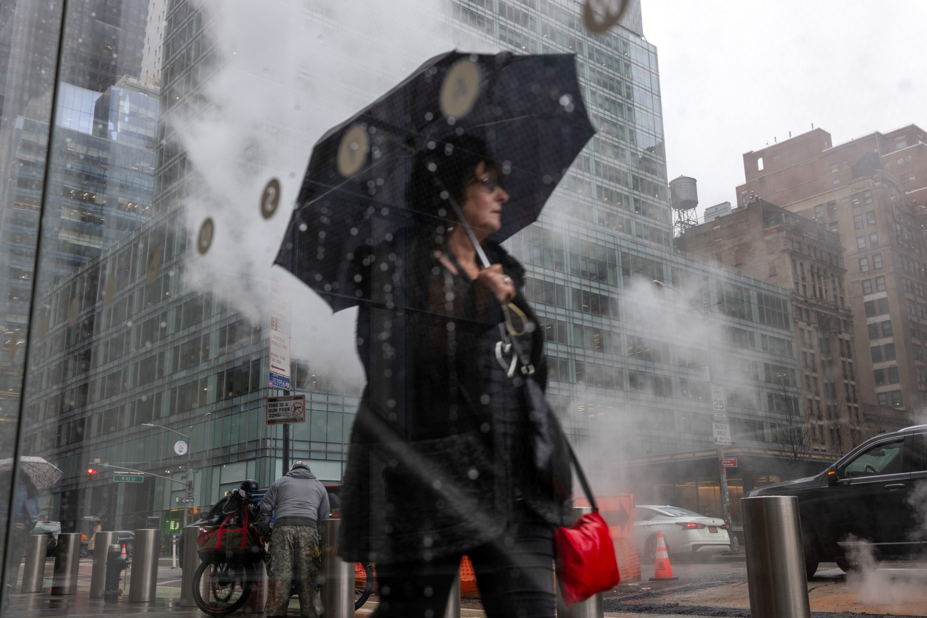 PHOTO: People walk through the rain in midtown Manhattan on March 05, 2024 in New York City.