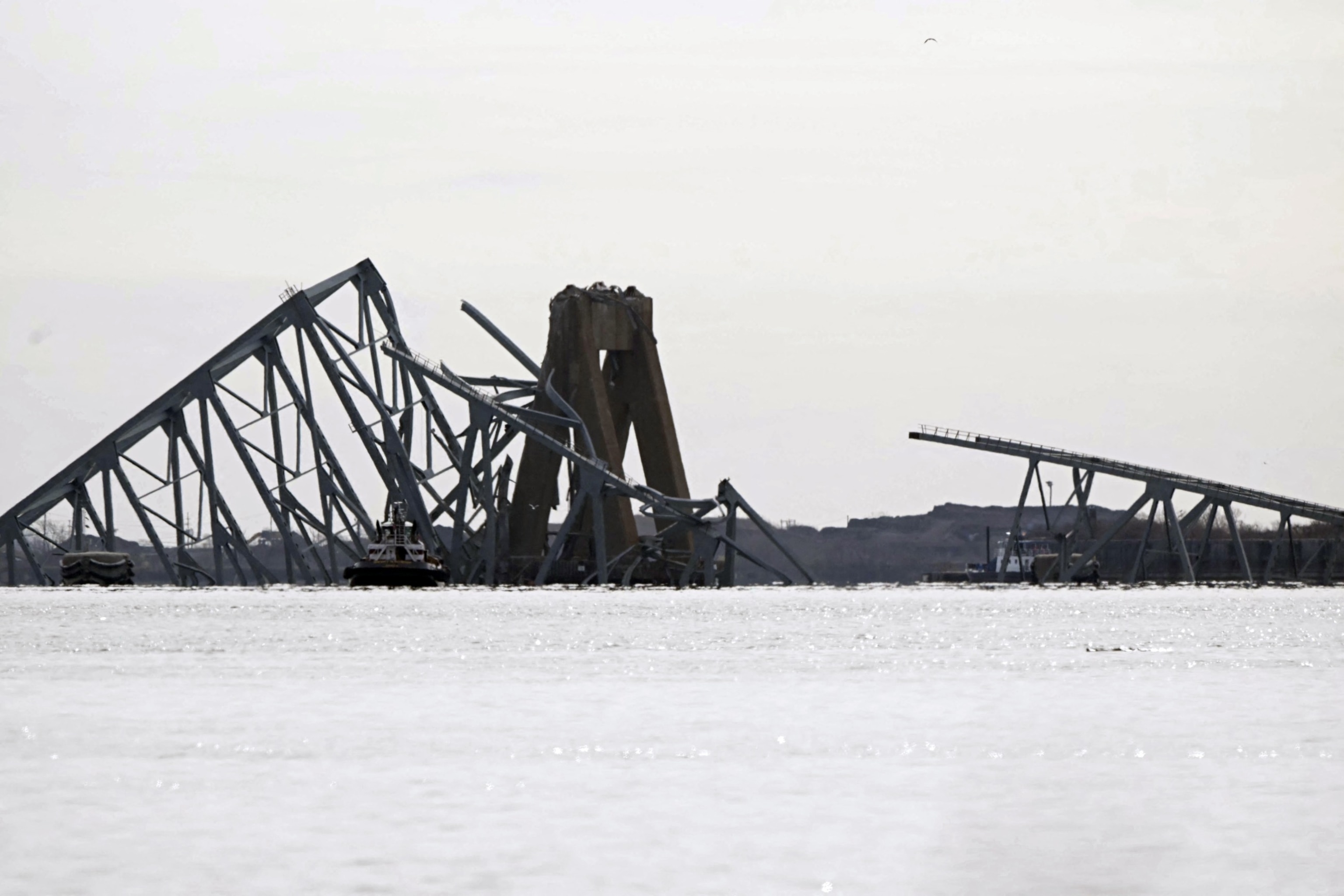 PHOTO: The steel frame of the Francis Scott Key Bridge lies in the water after it collapsed in Baltimore, March 26, 2024.