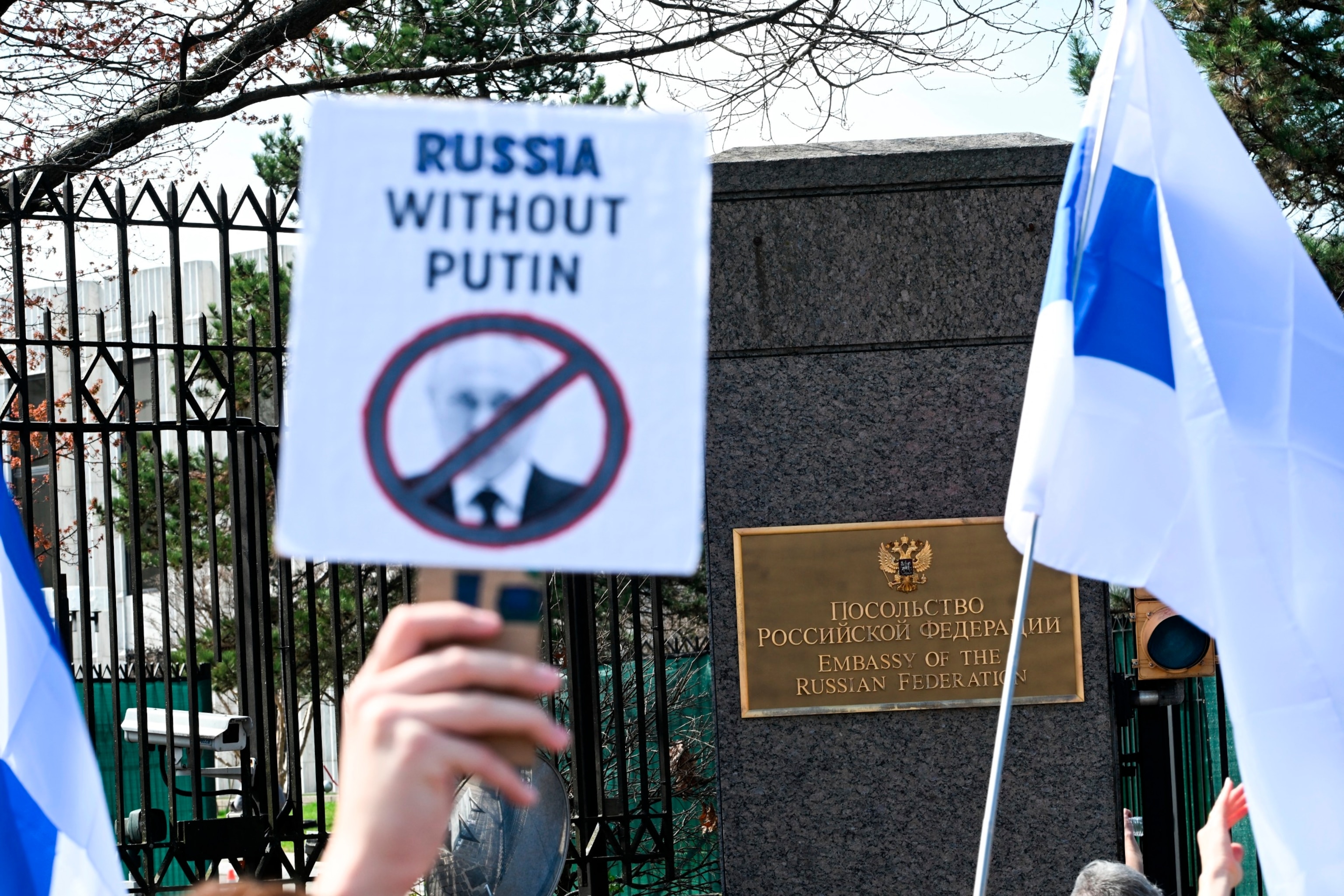 PHOTO: People take part in an anti Putin rally as voters queue outside the Russian embassy in Washington, DC, on March 17, 2024. 