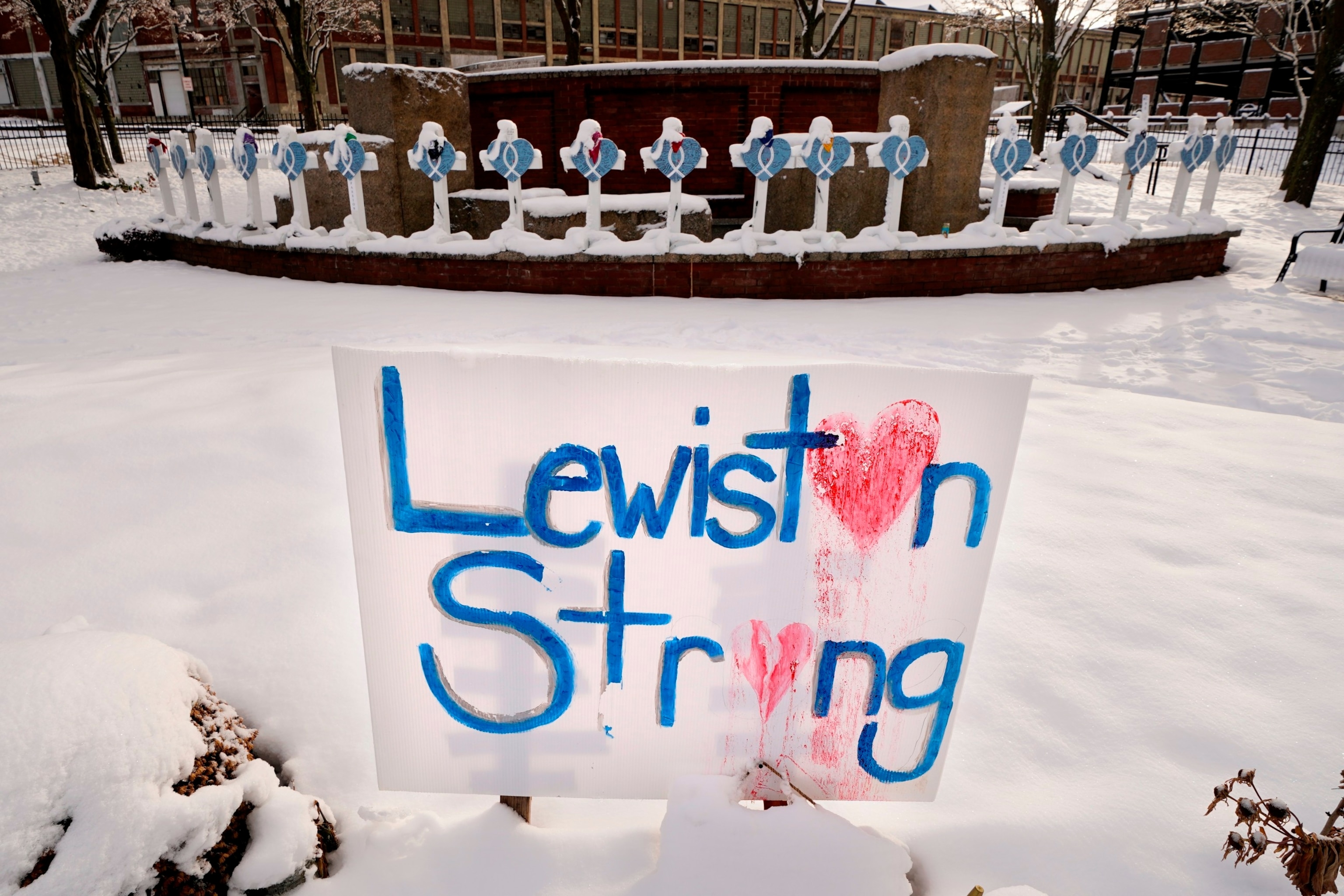 Recent snowfall coats crosses at one of several memorials for the victims of the Oct. 25 mass shooting in Lewiston, Maine, on Tuesday, Dec. 5, 2023. (AP Photo/Robert F. Bukaty, File)