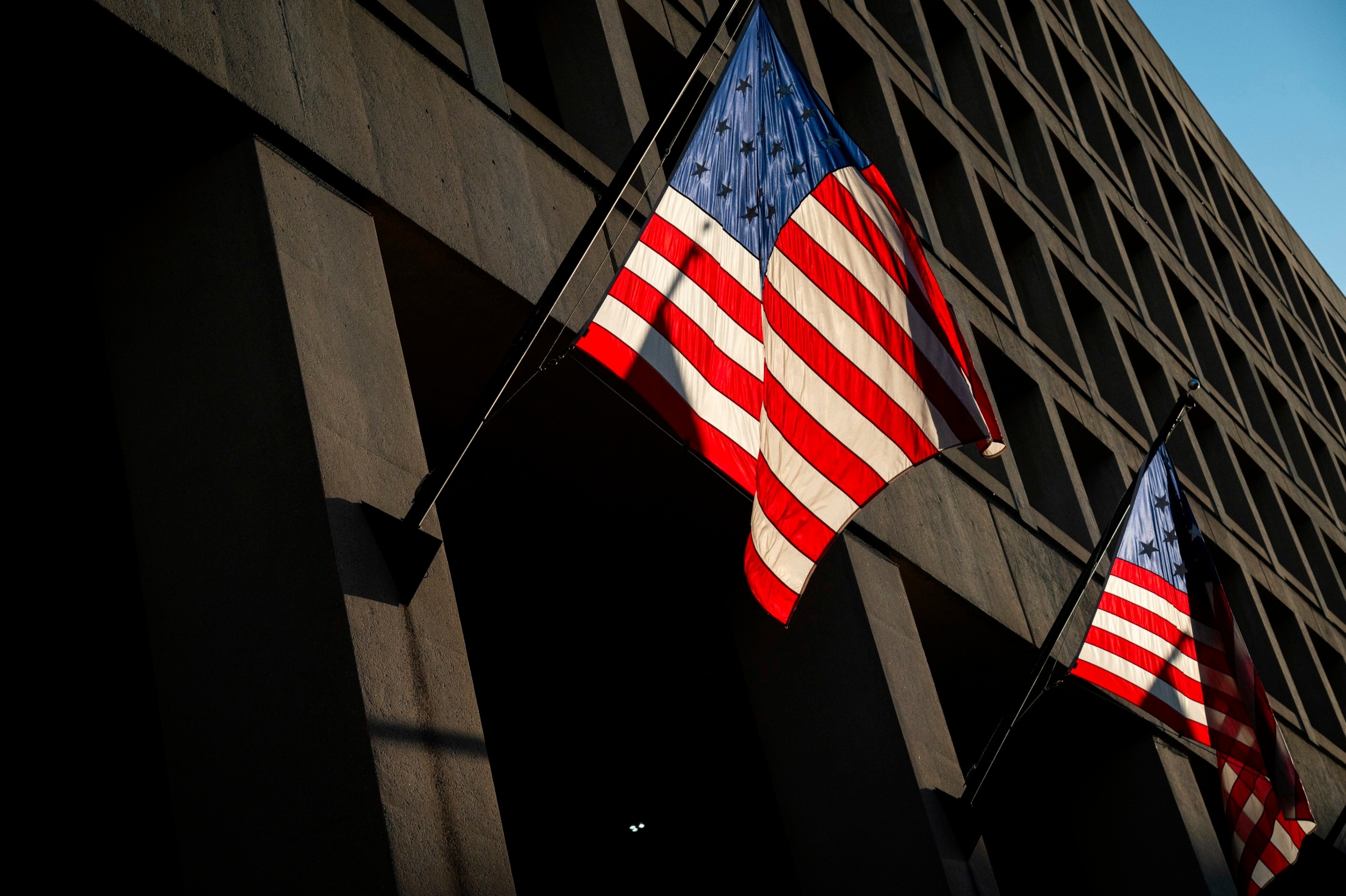 PHOTO: Sunlight illuminates flags at the U.S. Federal Bureau of Investigation (FBI) J. Edgar Hoover building, in Washington, D.C., Feb. 21, 2024.