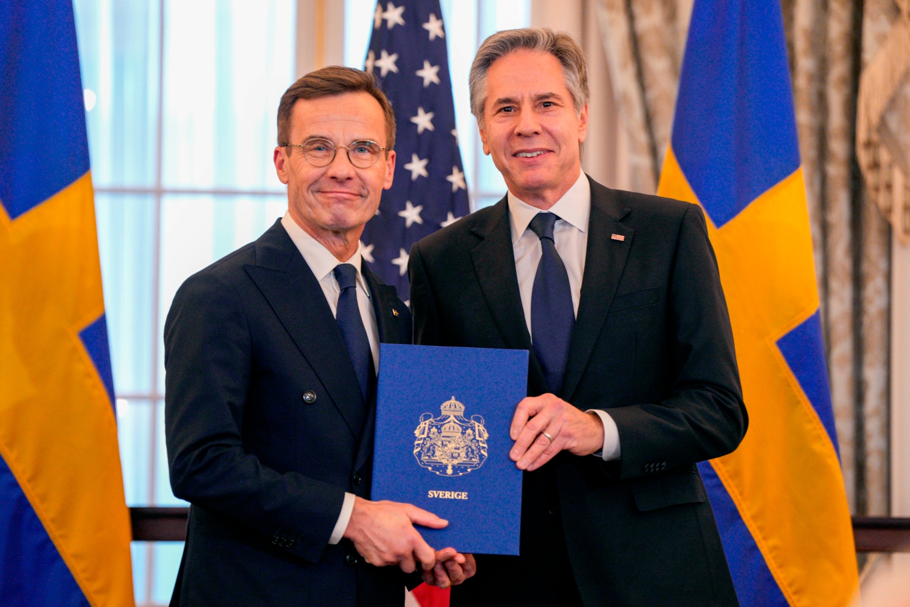 PHOTO: Secretary of State Antony Blinken stands with Swedish Prime Minister Ulf Kristersson holding Sweden's NATO Instruments of Accession at the State Department, Mar. 7, 2024, in Washington.