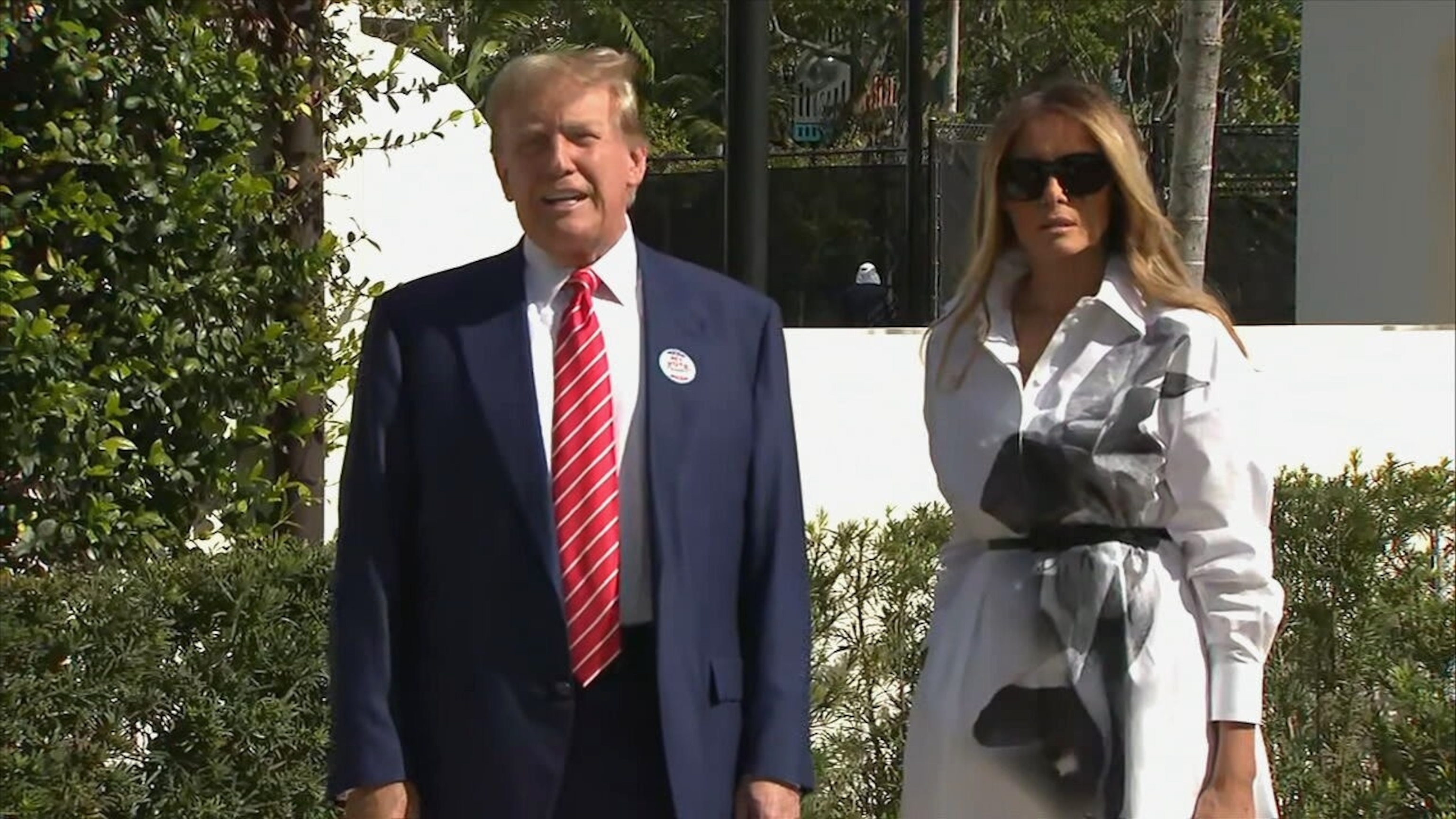 PHOTO: Former President Donald Trump speaks to the press while his wife Melania Trump looks on after voting in the primary election in West Palm Beach, Fla., on March 19, 2024.