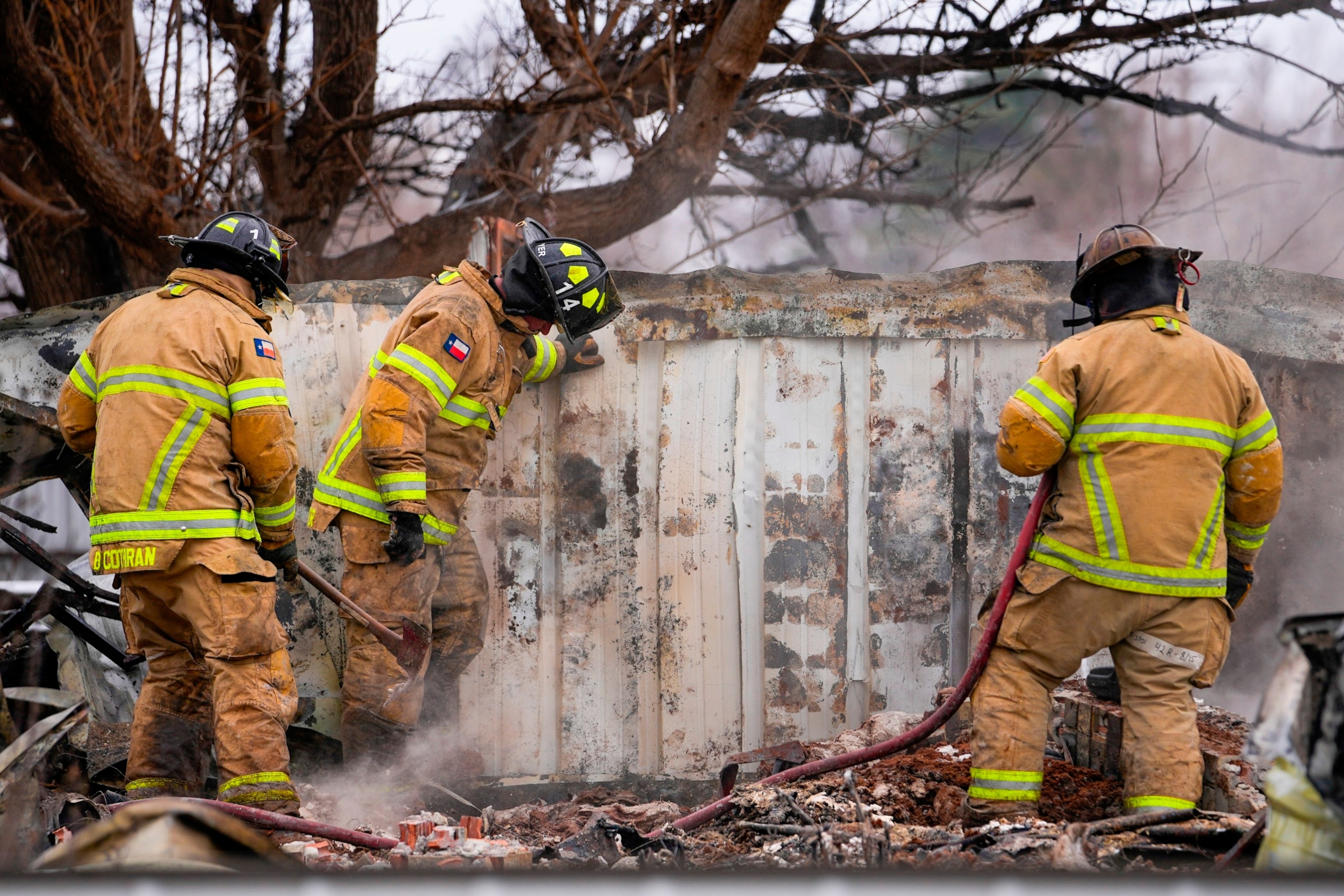 PHOTO: Fire officials from Lubbock, Texas, help put out smoldering debris of a home destroyed by the Smokehouse Creek Fire, Thursday, Feb. 29, 2024, in Stinnett, Texas.