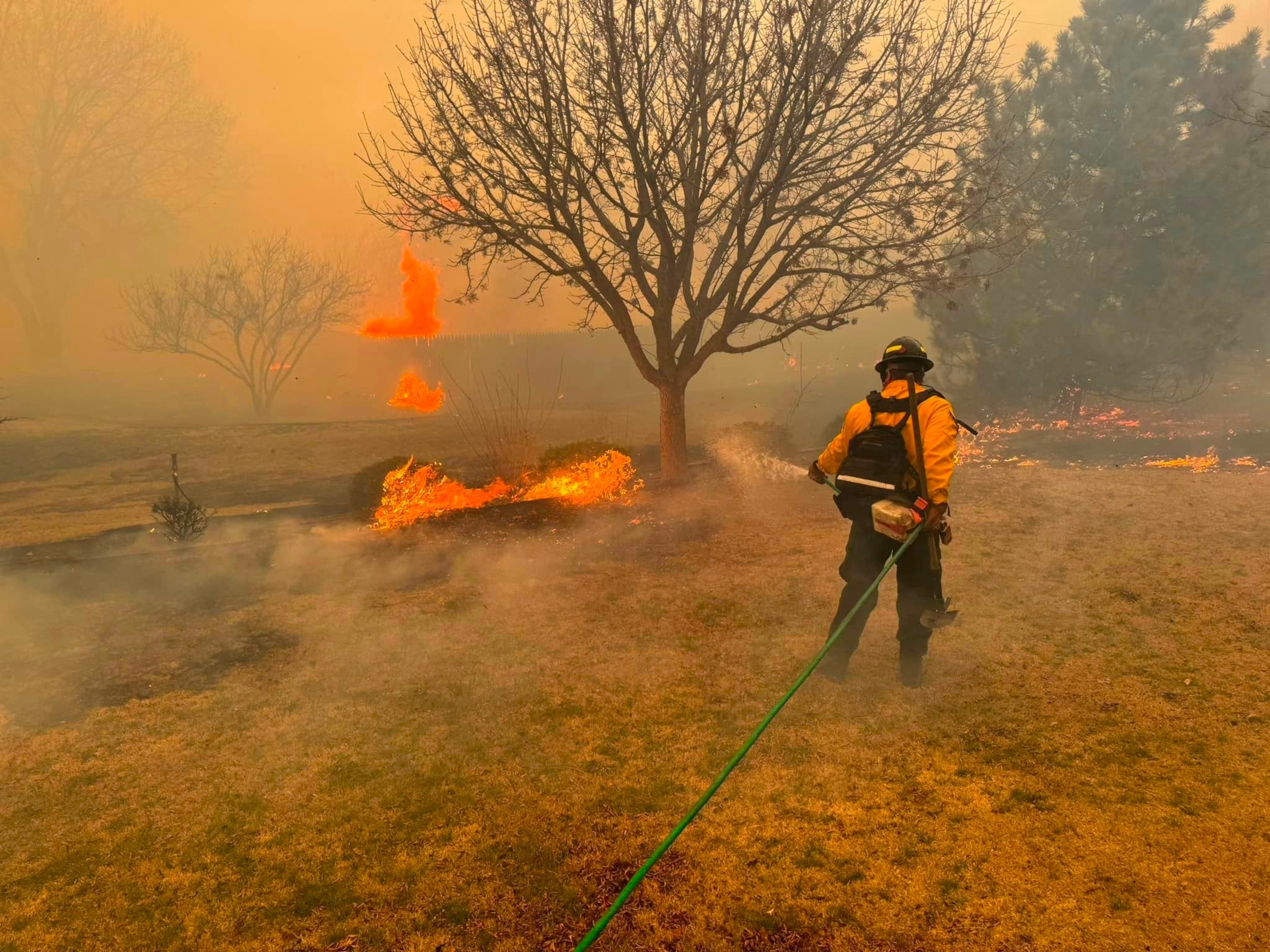 PHOTO: This handout picture courtesy of the Flower Mound Fire Department taken on Feb. 28, 2024, shows a firefighter battling the Smokehouse Creek Fire, near Amarillo, in the Texas Panhandle.