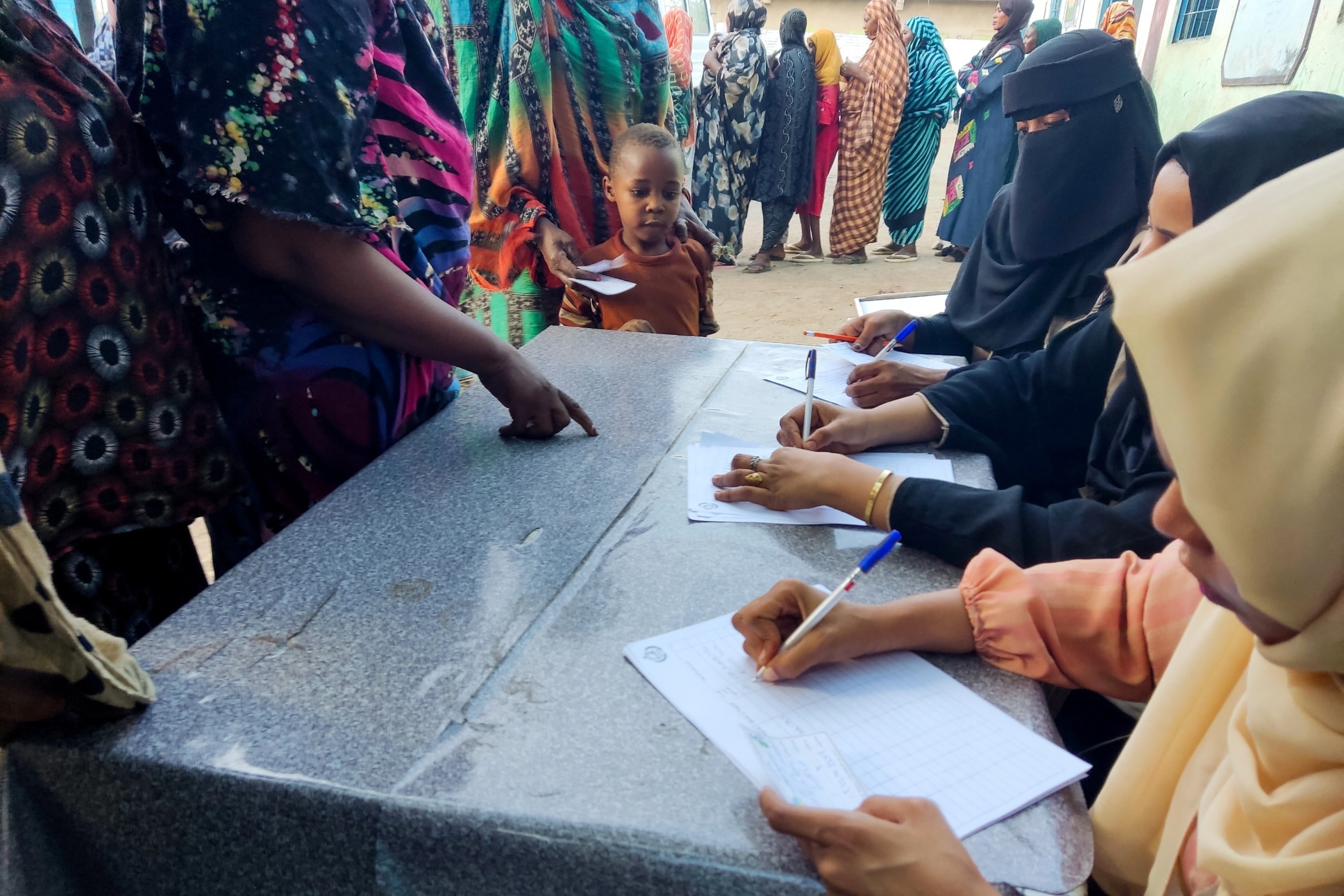 PHOTO: Internally displaced women register to collect aid from a group at a camp in Gadaref on May 12, 2024.