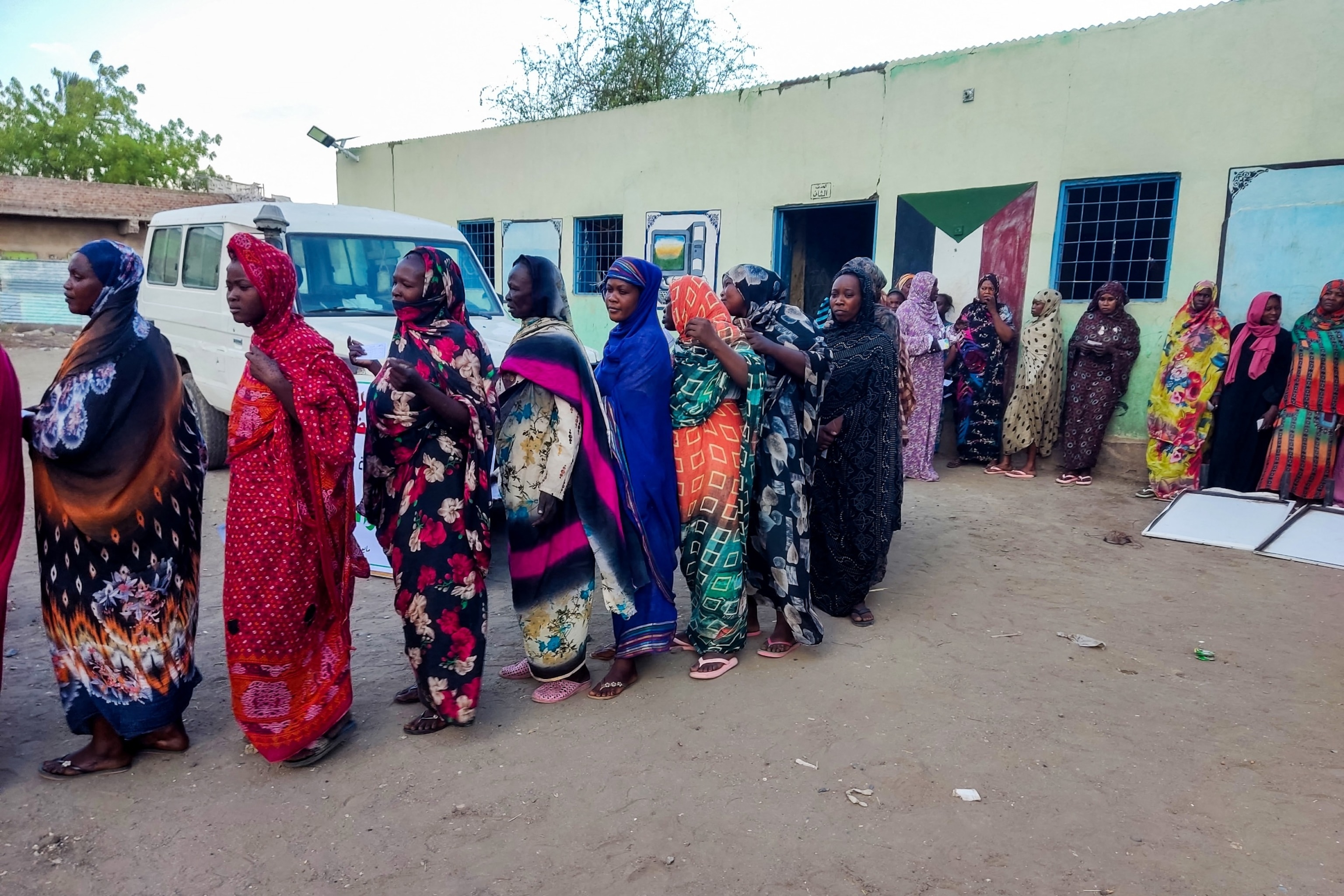 PHOTO: Internally displaced women wait in a queue to collect aid from a group at a camp in Gadaref on May 12, 2024.