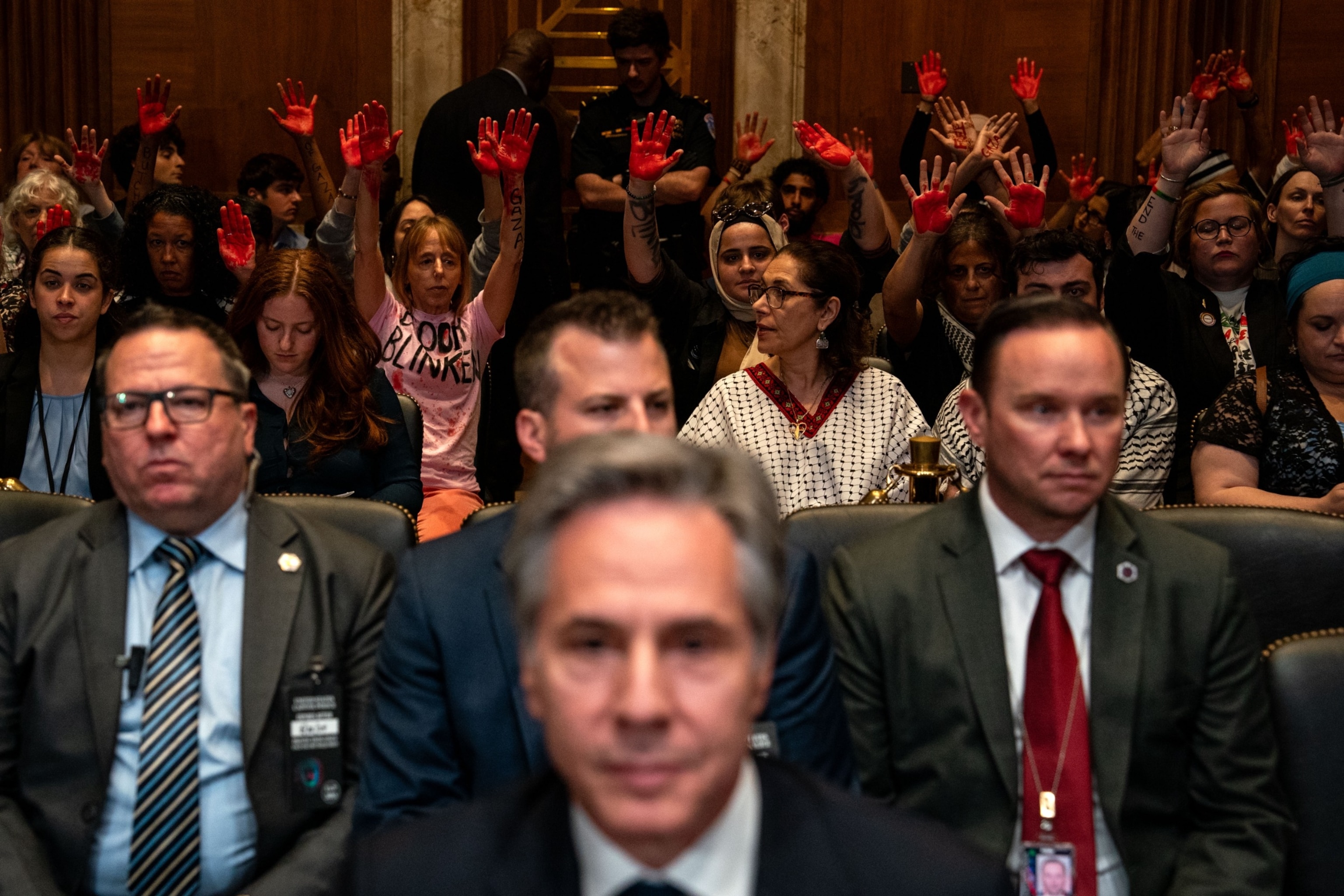 PHOTO: Pro-Palestinian demonstrators hold up painted hands as Secretary of State Antony Blinken arrives to testify for a Senate Appropriations subcommittee on state, foreign operations, and related programs hearing on Capitol Hill, May 21, 2024.