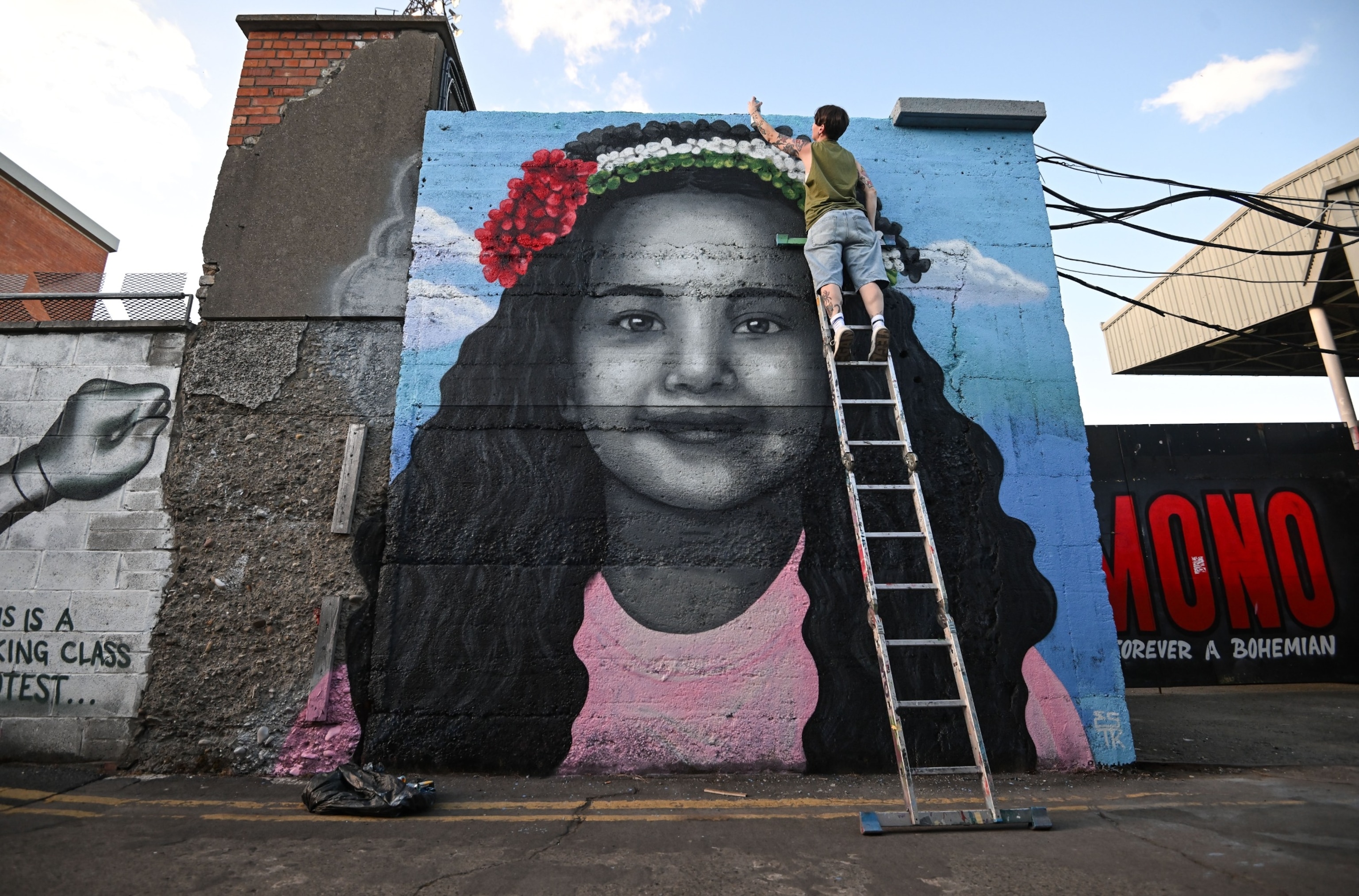 PHOTO: Artist Emmalene Blake puts the final touches to a mural of Hind Rajab, the 6-year-old Palestinian girl who was killed in Gaza, along with several family members and paramedics, in Dublin, Ireland, May 15, 2024.