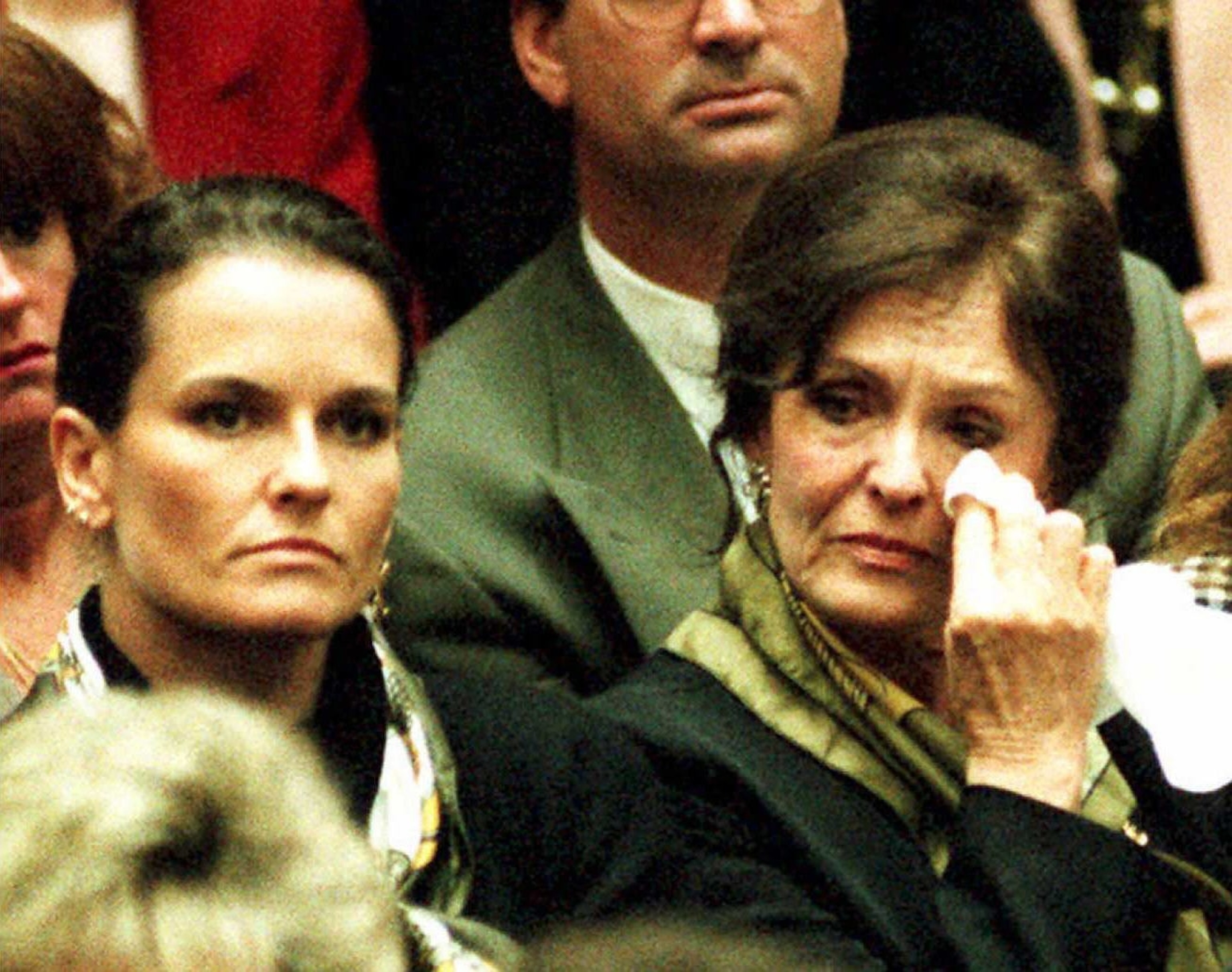 PHOTO: Mother Juditha Brown (R) wipes tears from her eyes as she listens with daughter Denise to prosecutor Christopher Darden's opening statements in the O.J. Simpson murder trial January 24, 1995, in Los Angeles.