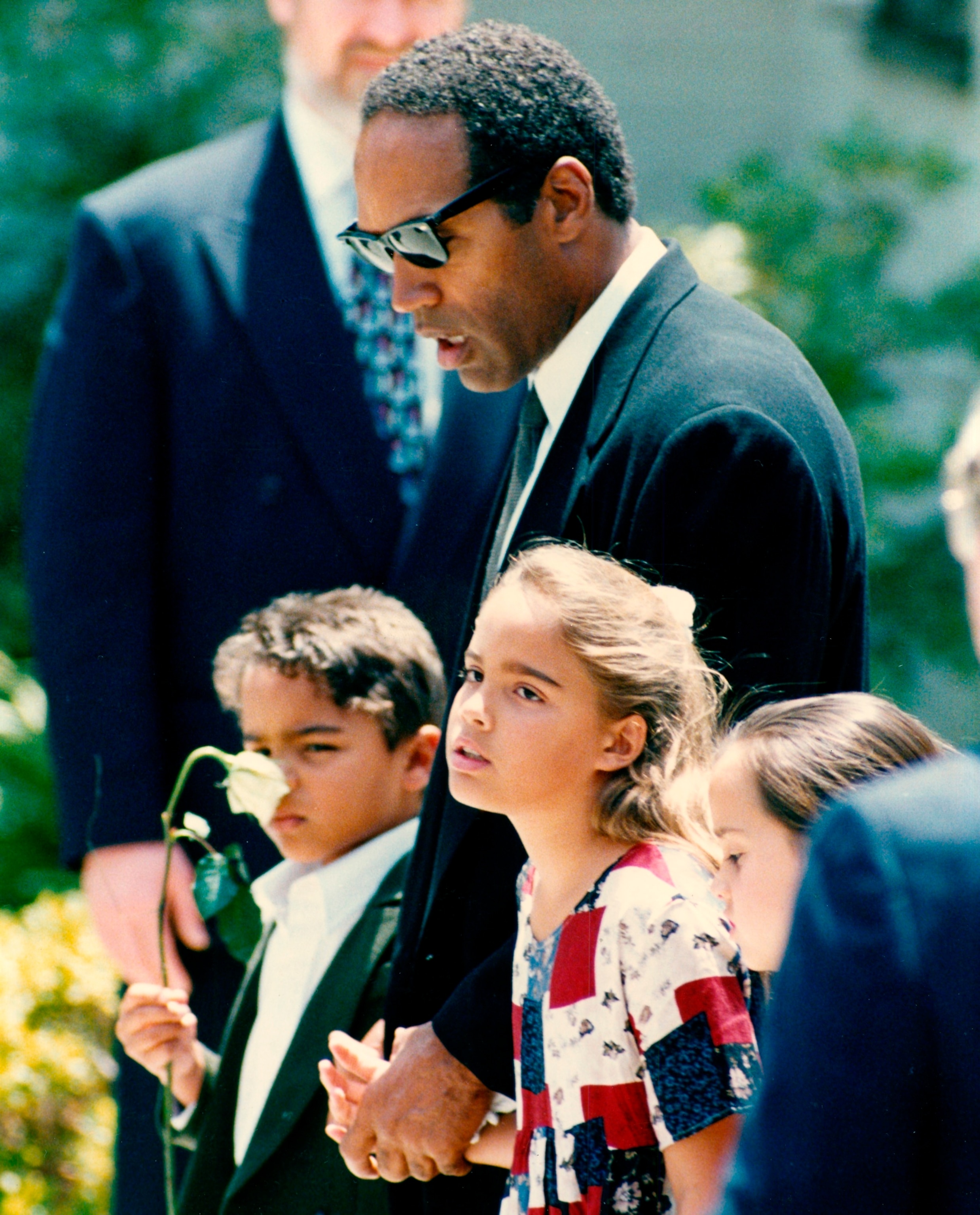 PHOTO: American football player and actor O J Simpson holding hands with his children Justin and Sydney at the funeral of their mother, and his ex-wife, Nicole Simpson Brown following her murder, Los Angeles, June 16, 1994.