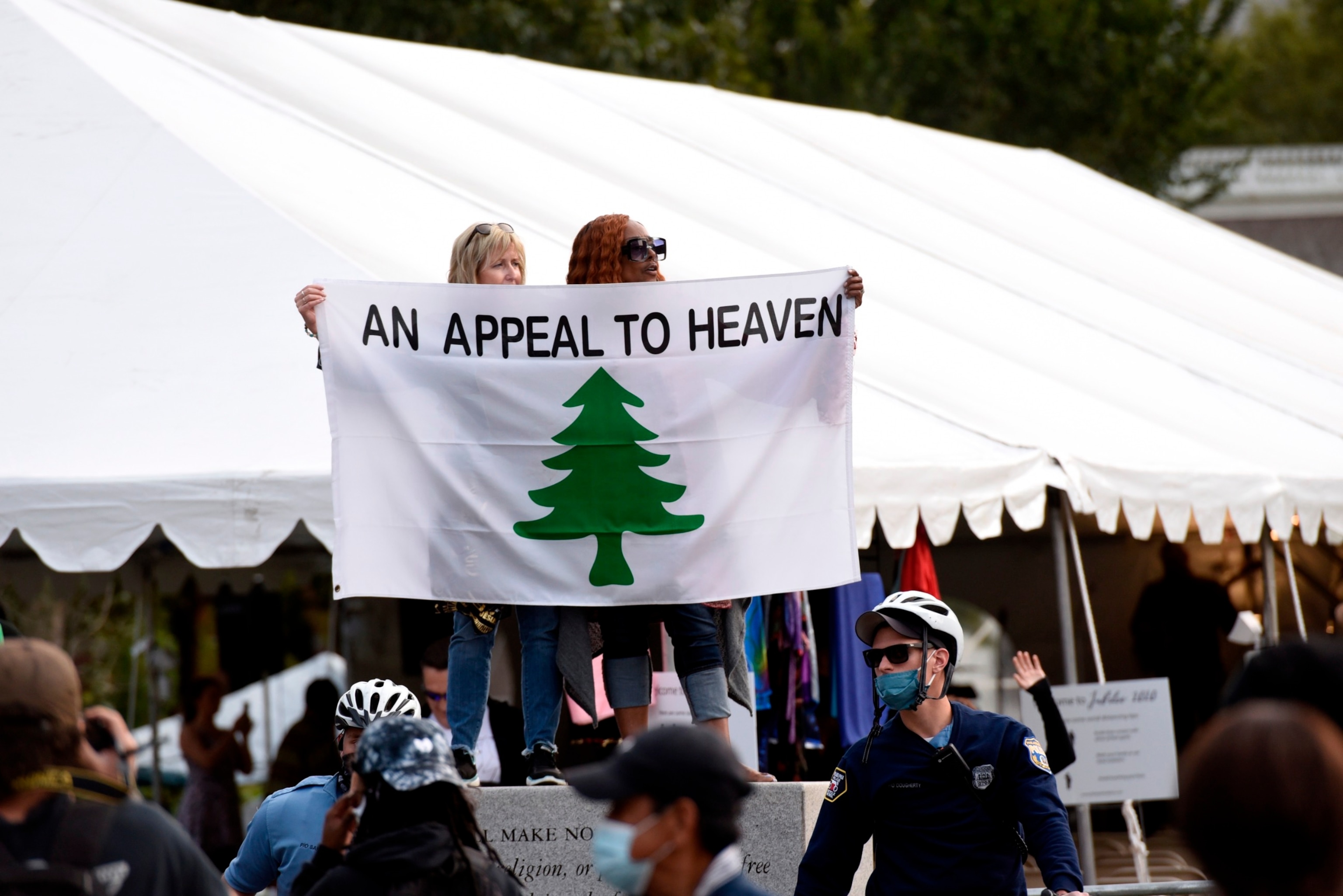 PHOTO: People carry an "Appeal To Heaven" flag as they gather at Independence Mall to support President Donald Trump during a visit to the National Constitution Center to participate in the ABC News town hall, Sept. 15, 2020, in Philadelphia.