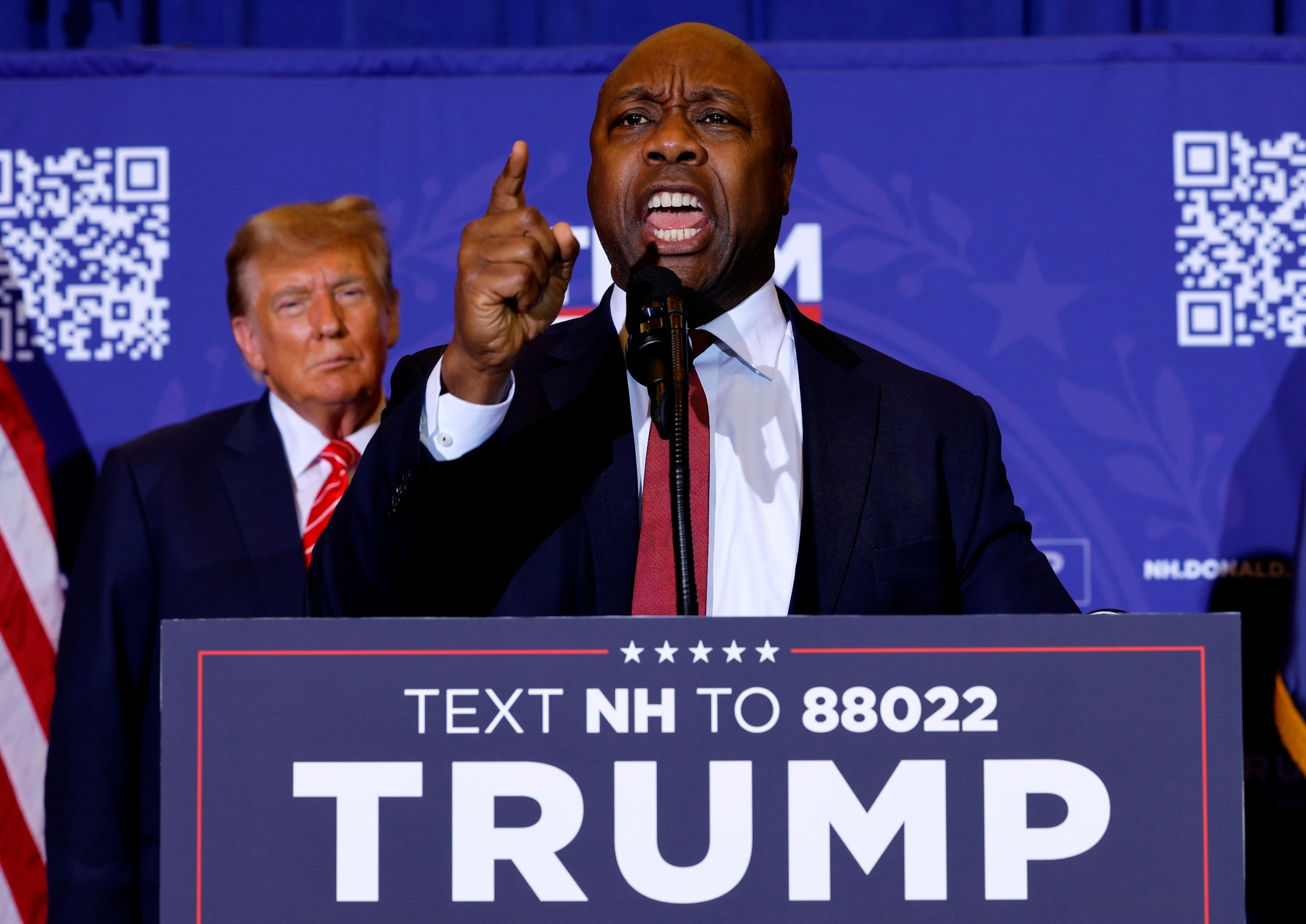 PHOTO: Sen. Tim Scott speaks as former President Donald Trump looks on during a campaign rally at the Grappone Convention Center in Concord, NH, Jan. 19, 2024.