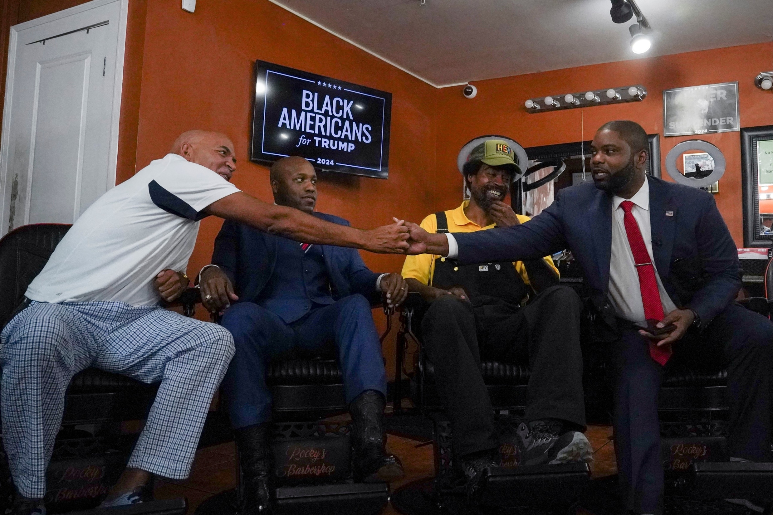 PHOTO: Radio host Wynter and Congressman Donalds shake hands at a round table discussion hosted by former President Trump during a campaign stop for a "Black American Business Leaders Barbershop Roundtable" at Rocky's Barbershop in Atlanta, June 26, 2024.