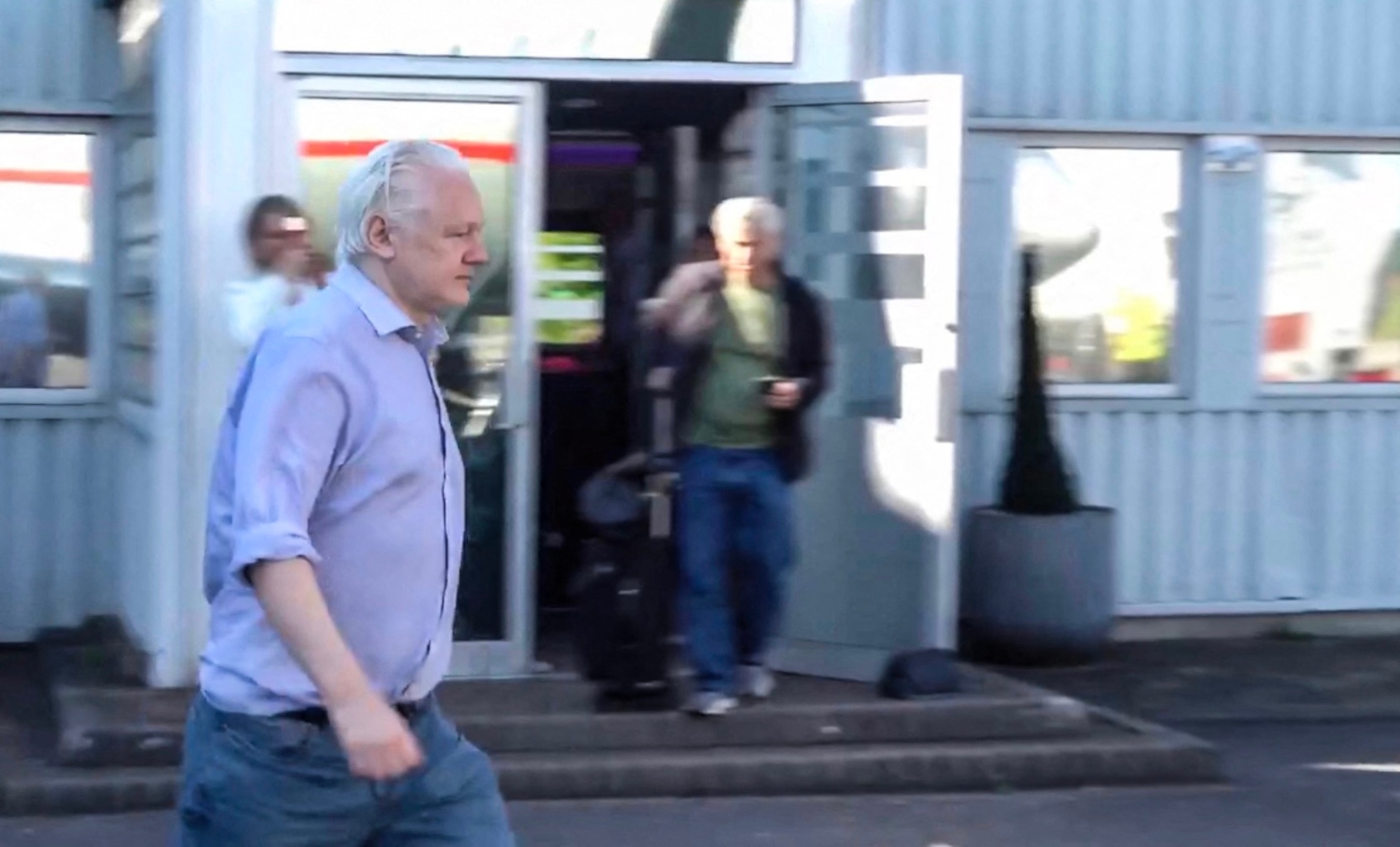 PHOTO: This screen shot courtesy of WikiLeaks' X page shows Wikileaks founder Julian Assange walking to board a plane from London Stansted Airport on June 24, 2024.