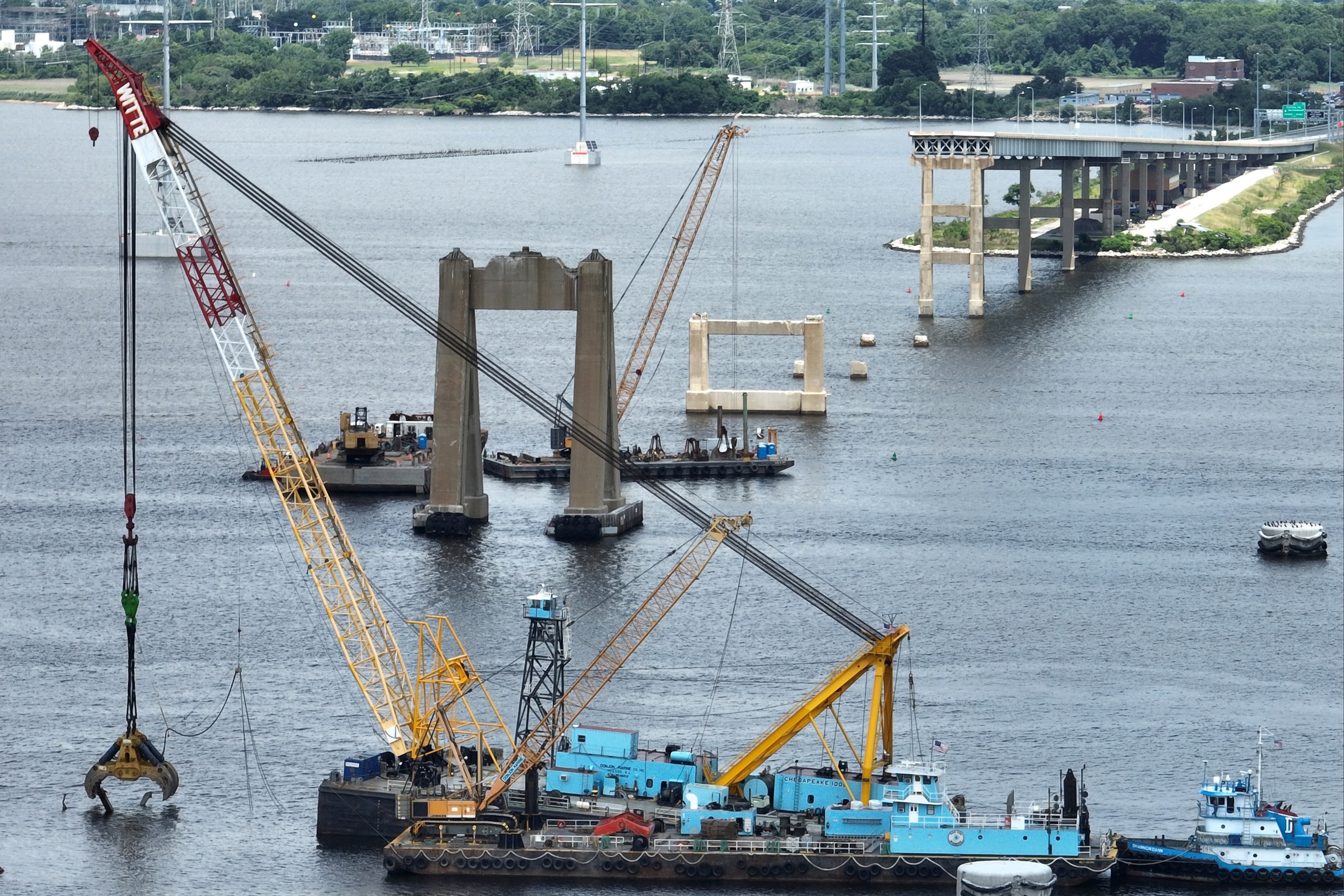 PHOTO: In an aerial view, salvage crews continue to clean up wreckage from the collapse of the Francis Scott Key Bridge in the Patapsco River on June 11, 2024 in Baltimore, Maryland. 