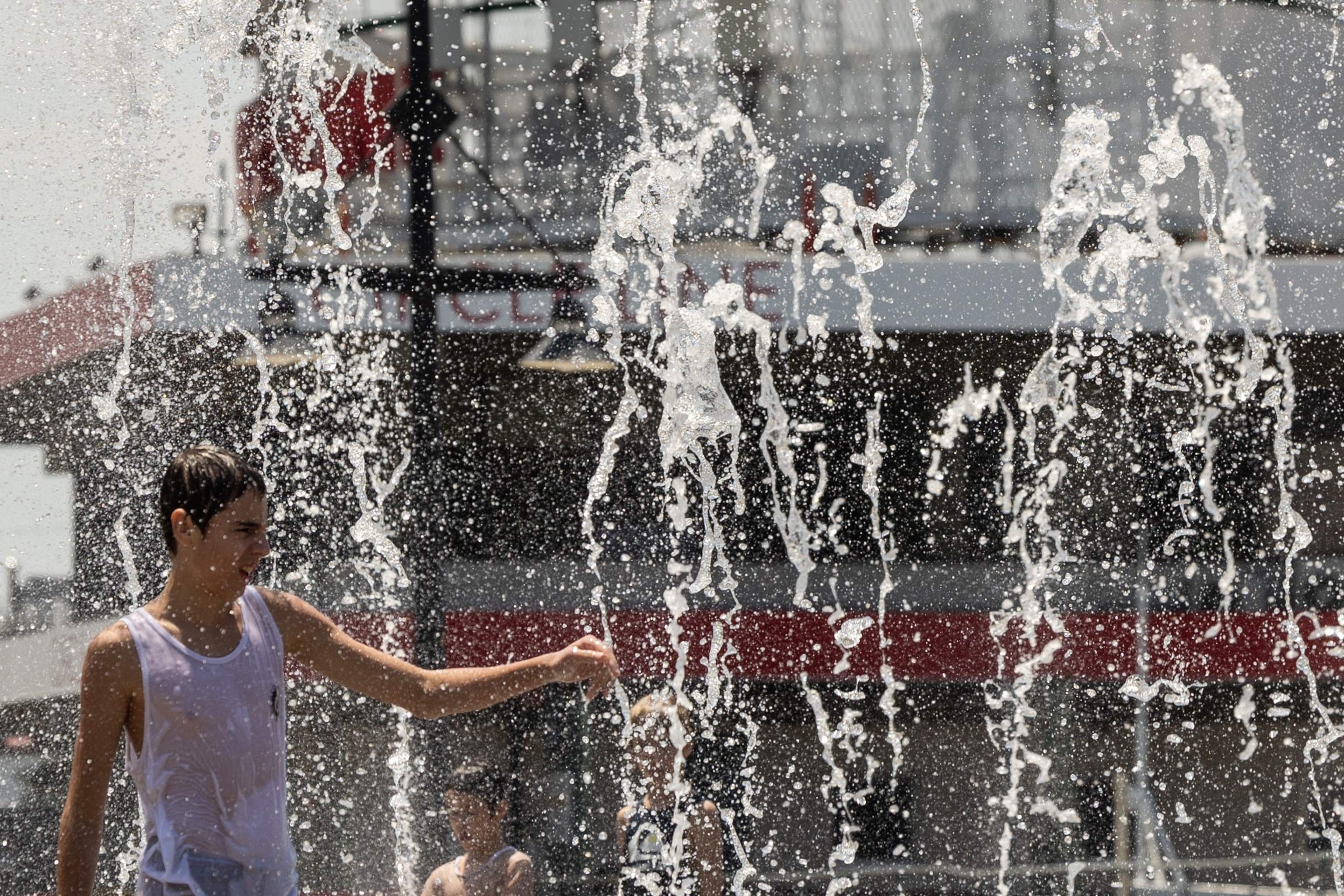 PHOTO: A person cools off in a water fountain near the Hudson River during a heatwave in New York City, June 20, 2024.
