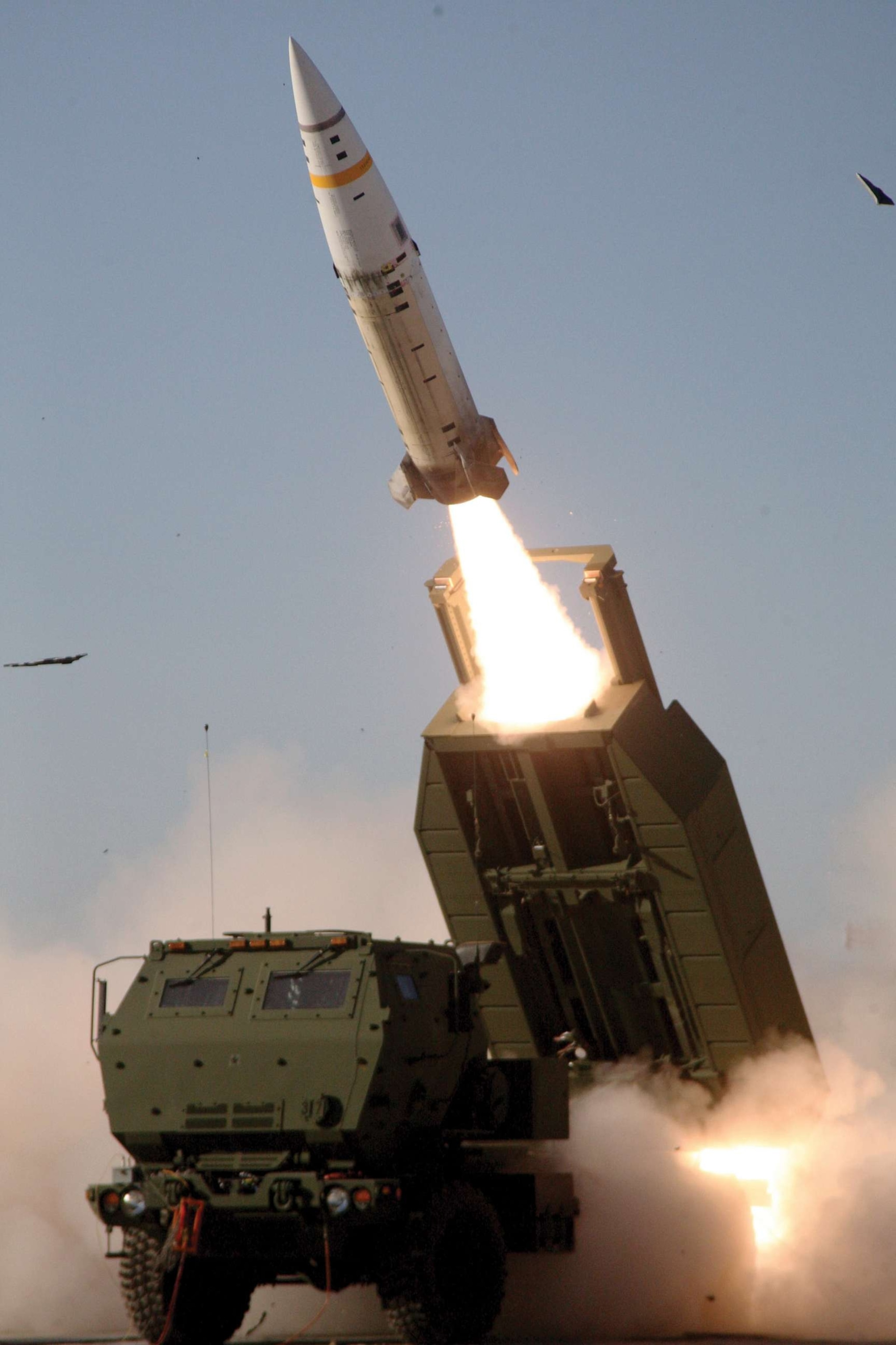 PHOTO: The M57A1 Army Tactical Missile System missile is fired over the cab of an M142 High Mobility Artillery Rocket System launcher.