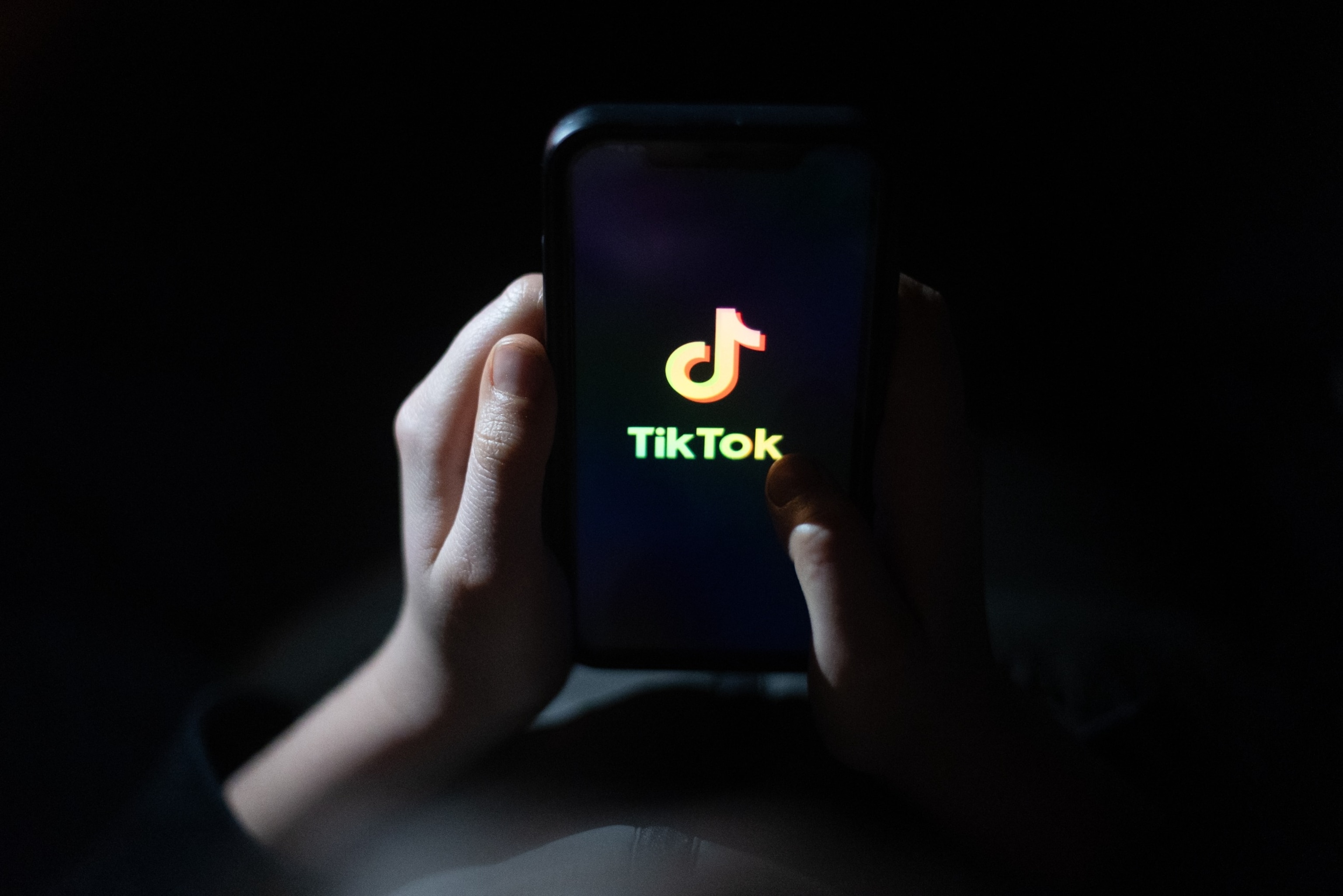 PHOTO: A child holds a smartphone screen displaying the TikTok logo, March 10, 2024.