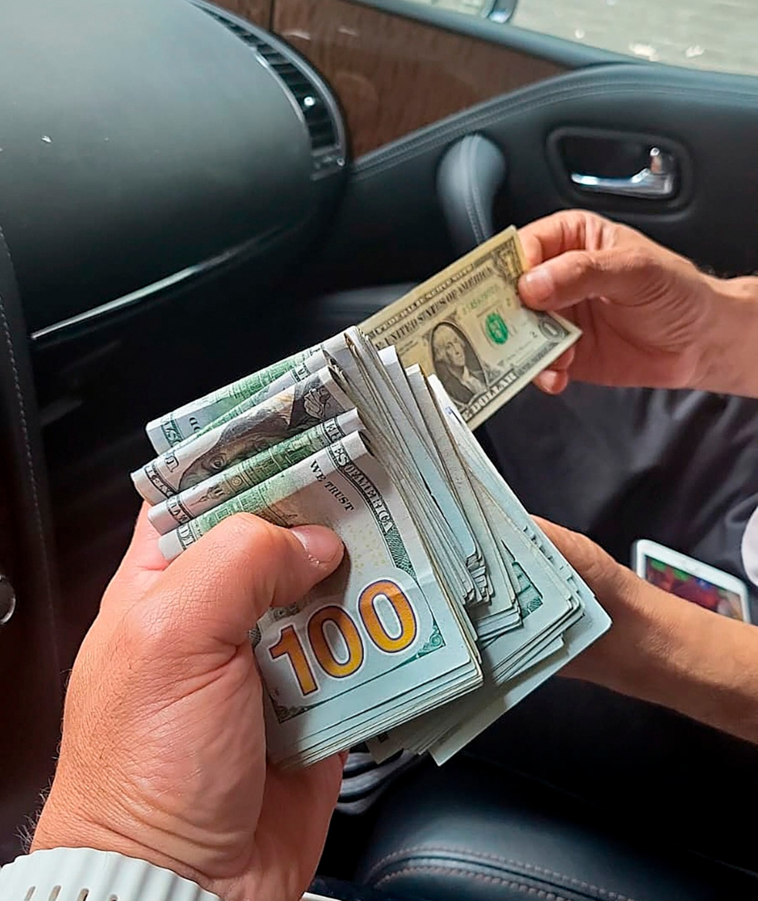PHOTO: In this June 2023 photo provided by the U.S. Attorney's Office, an undercover agent posing as a hitman holds money received as an advance payment for the murder of Gurpatwant Singh Pannun, an American citizen, during a transaction in New York.