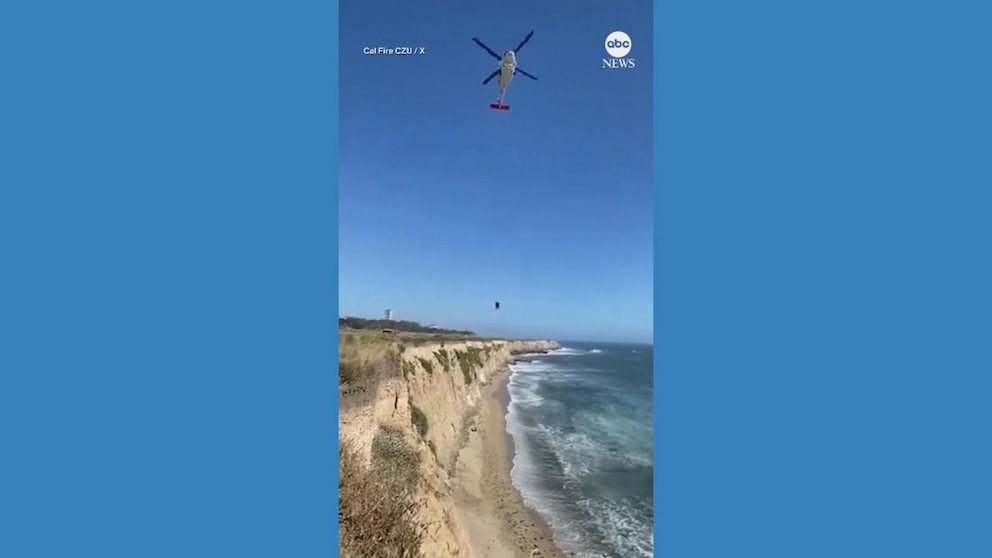 Kite surfer stranded on beach creatively signals for help using rocks