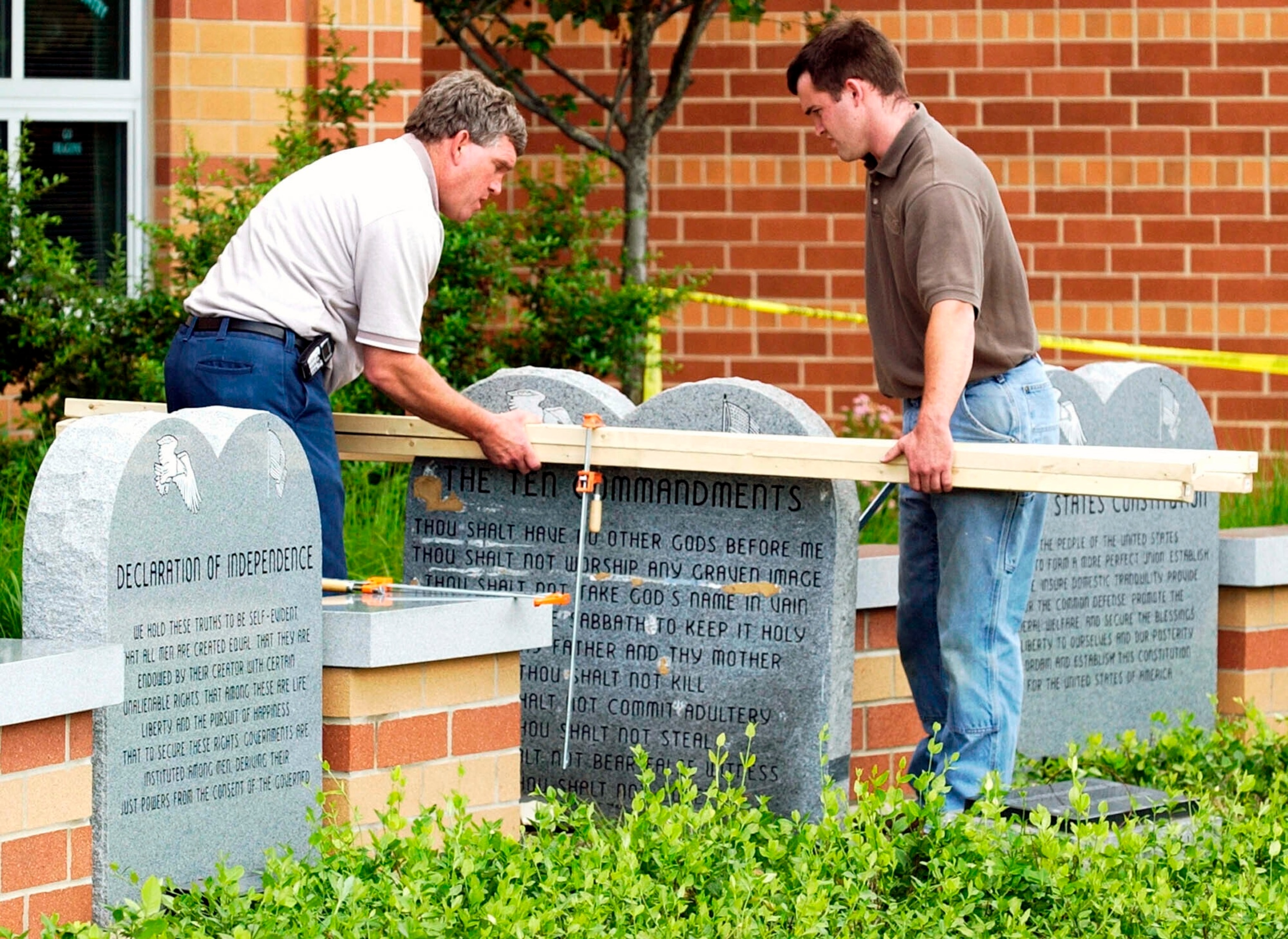 PHOTO: Workers remove a monument bearing the Ten Commandments outside West Union High School, June 9, 2003, in West Union, Ohio. 