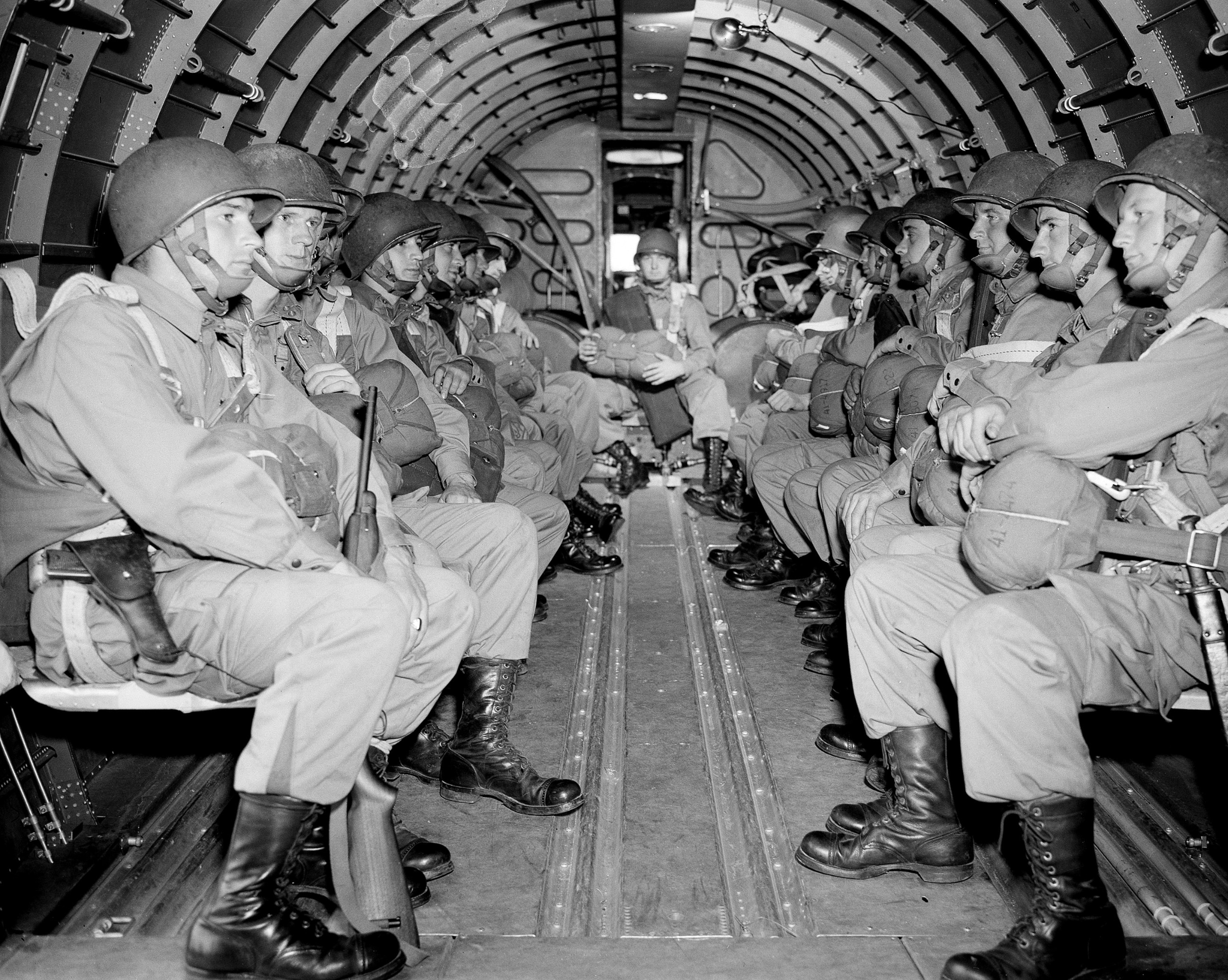 PHOTO: American paratroopers, heavily armed, sit inside a military plane as they soar over the English Channel en route to the Normandy French coast for the Allied D-Day invasion of the German stronghold during World War II, June 6, 1944. 