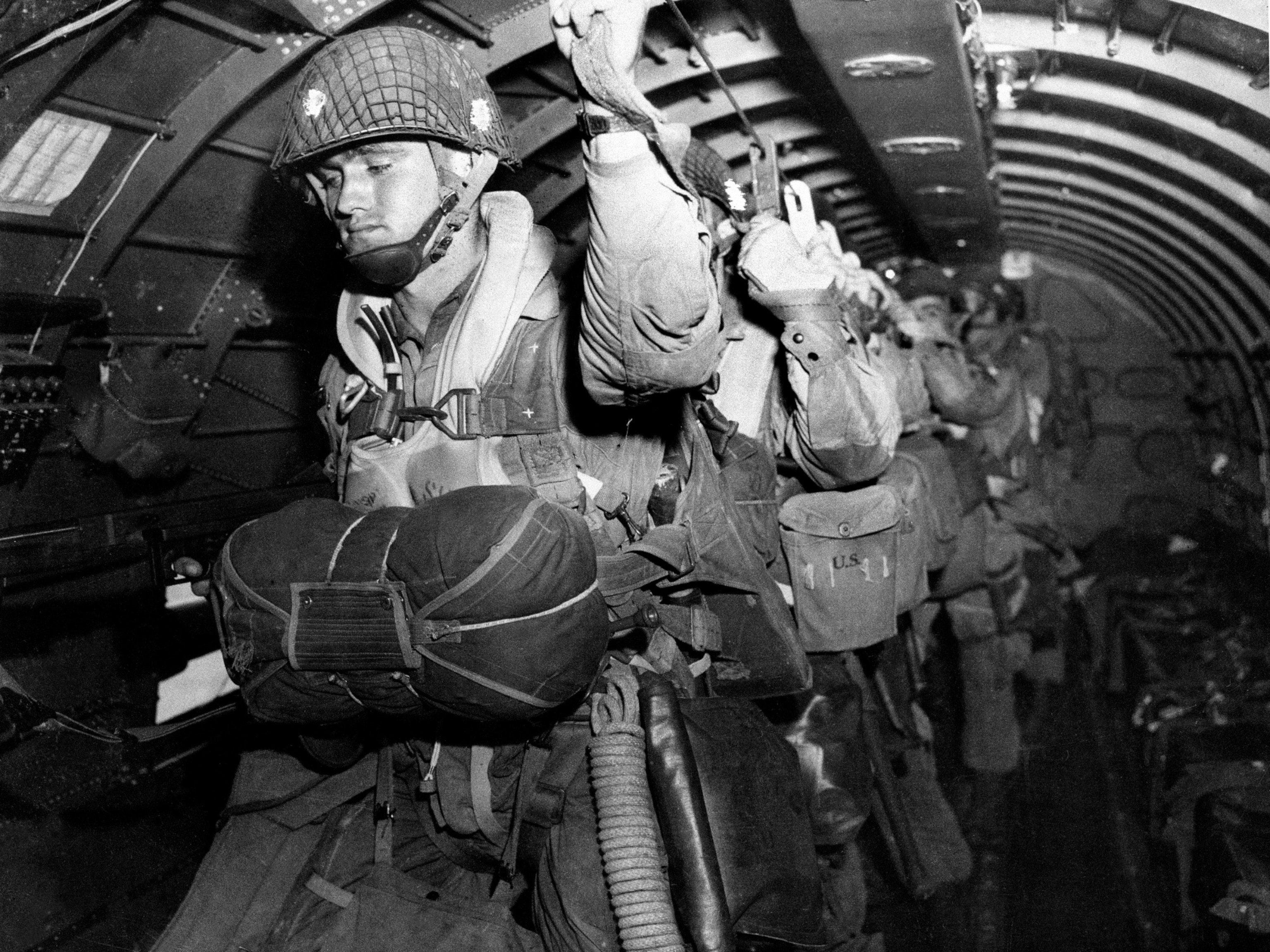 PHOTO: In this photo provided by the U.S. Army Signal Corps, U.S. paratroopers fix their static lines before a jump before dawn over Normandy on D-Day, June 6, 1944, in France.