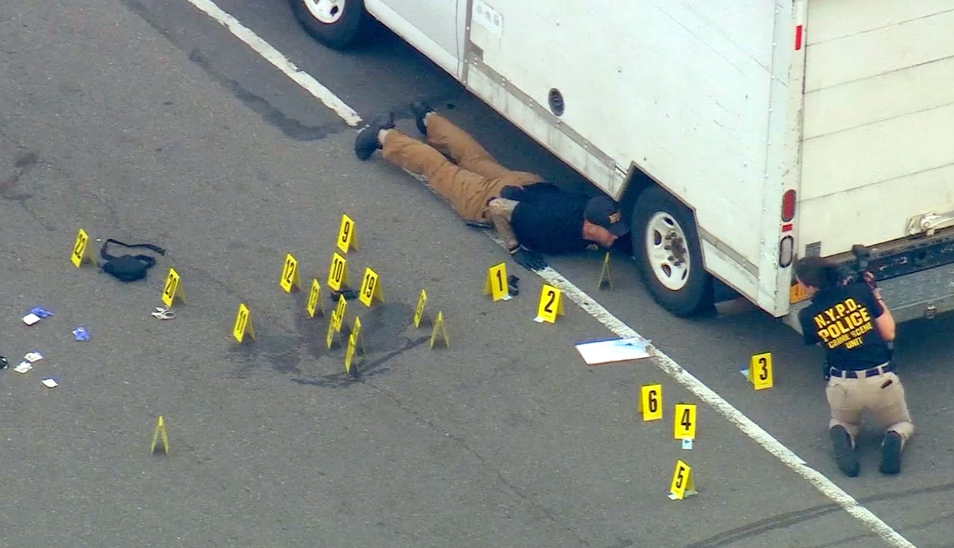 PHOTO:  Investigators look for evidence after an NYPD officer was shot in a shootout with a robbery suspect, June 3, 2024, in the Queens borough of New York City.

