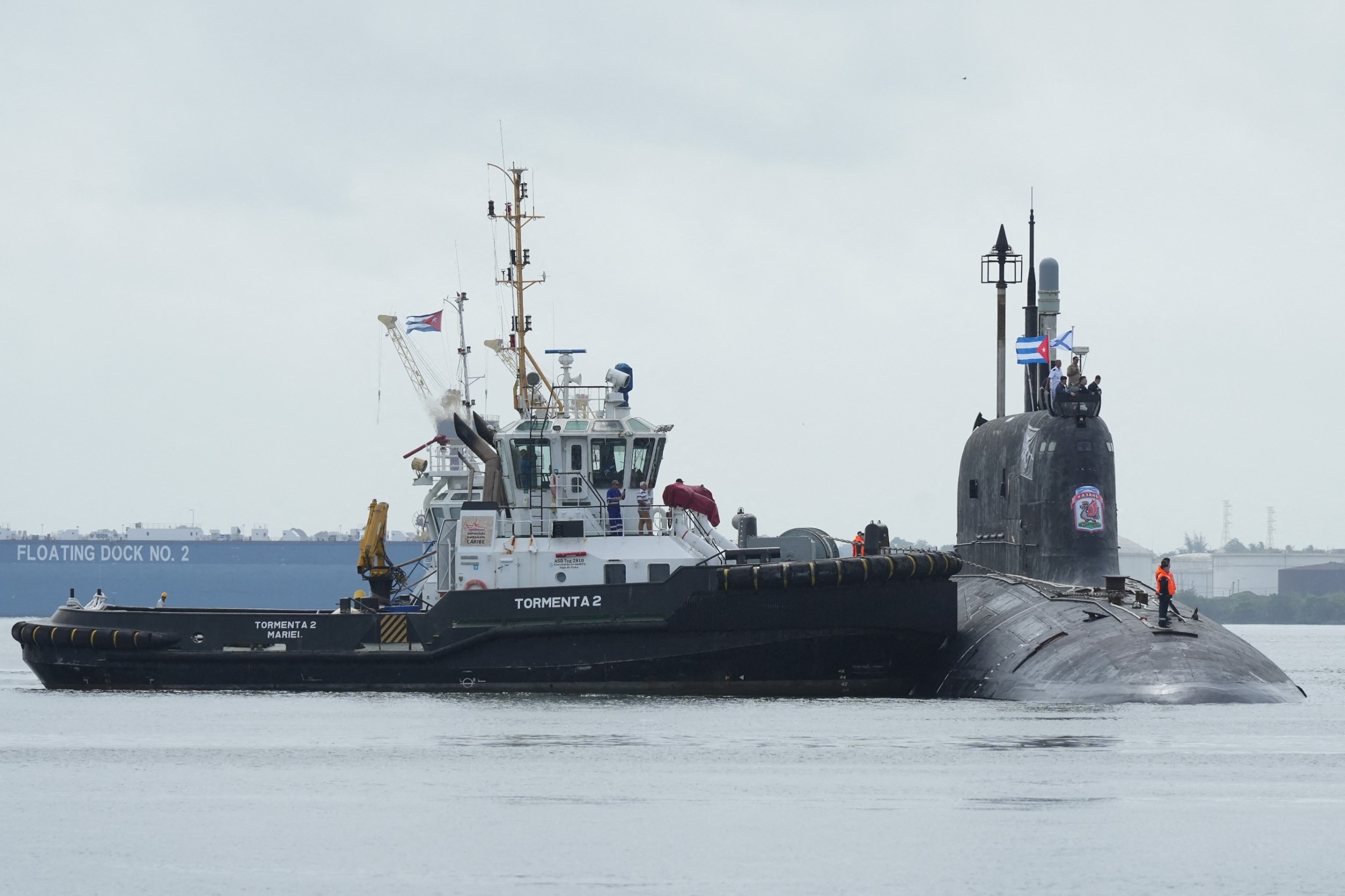 PHOTO: A tug boat manoeuvres Russian nuclear-powered cruise missile submarine Kazan as it docks in Havana's bay, Cuba, June 12, 2024. 