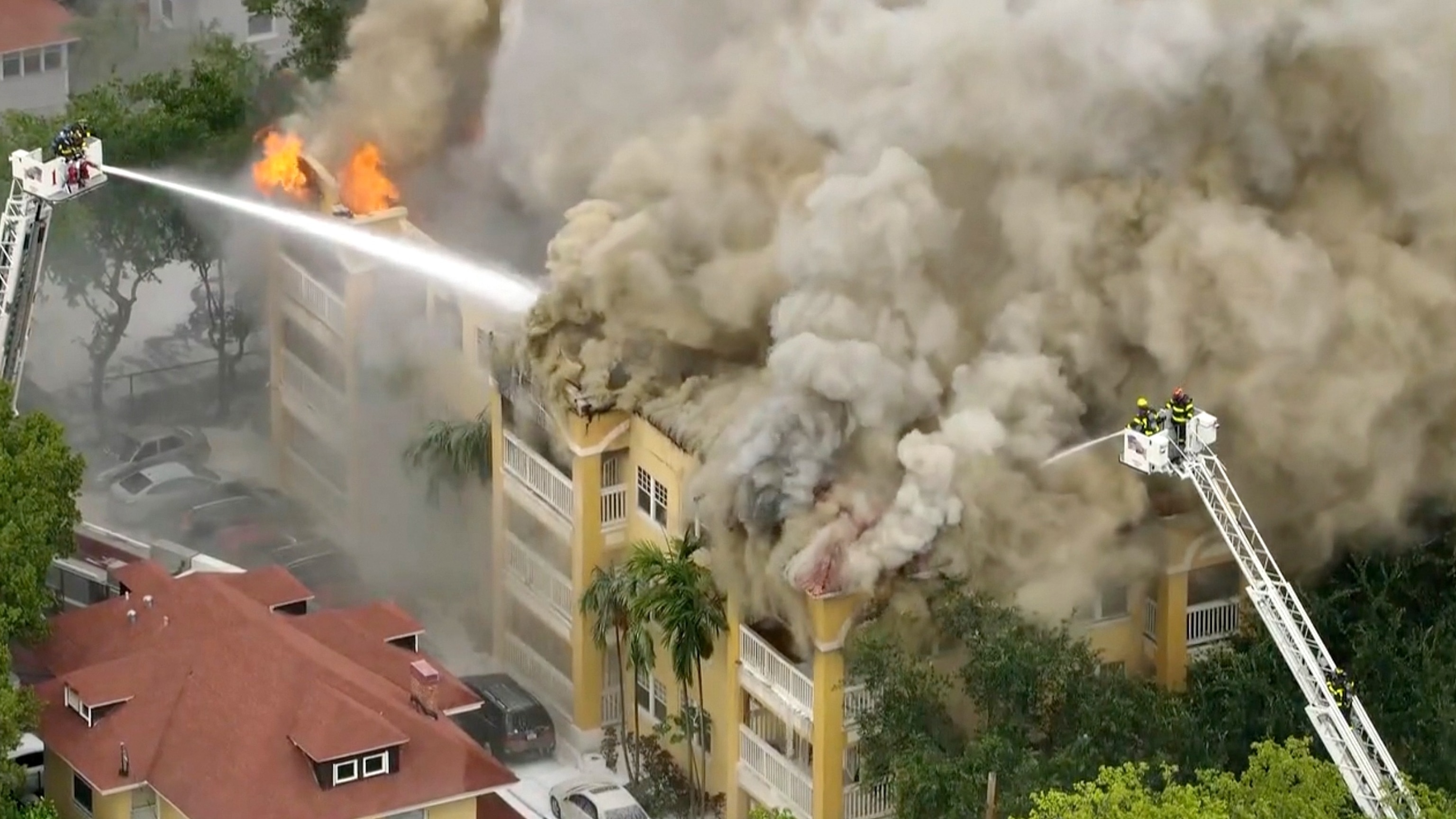 PHOTO: Firefighters work to extinguish a fire at a four-story apartment building in the city of Miami, June 10, 2024.