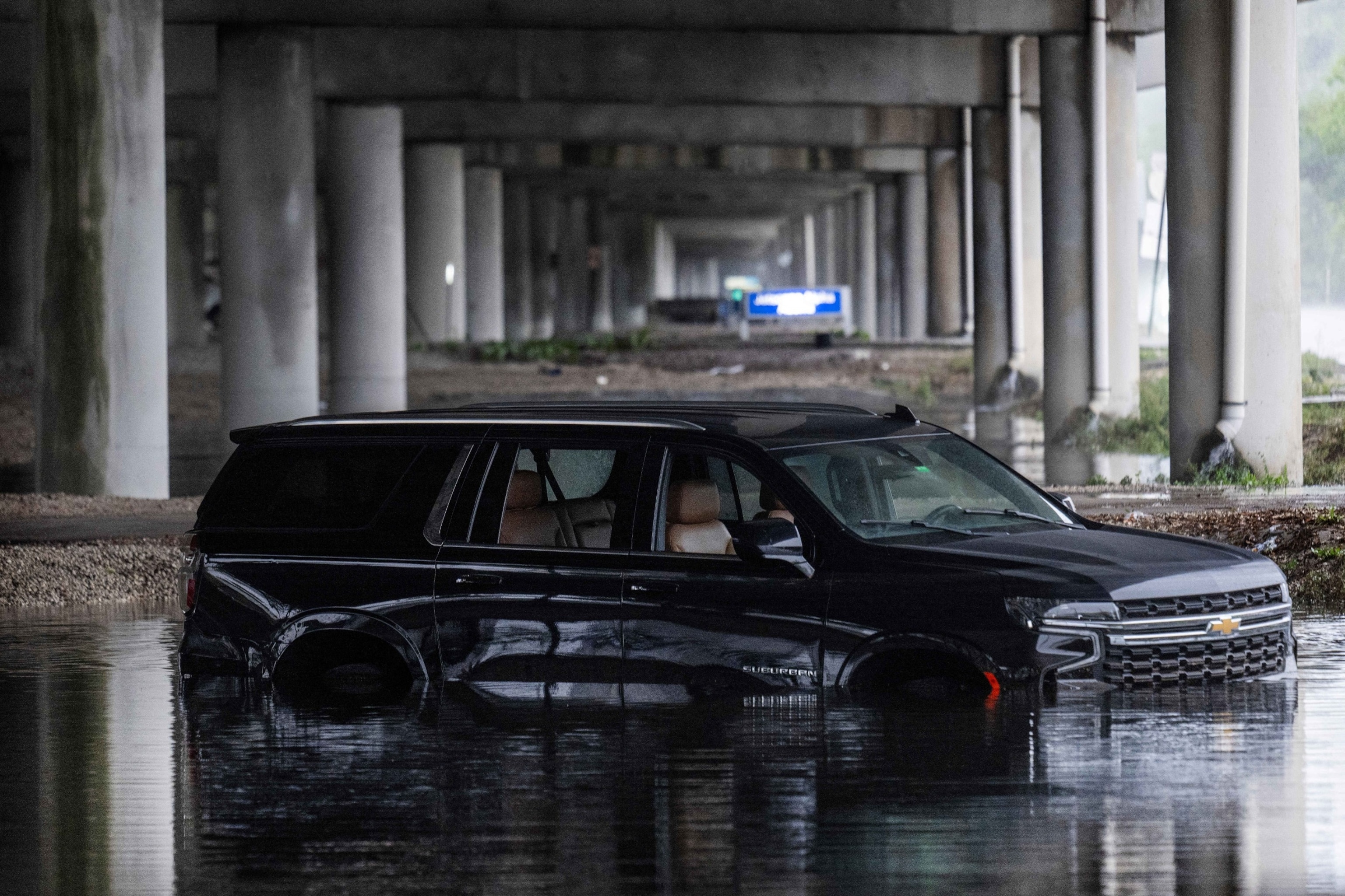 PHOTO: An abandoned car sits submerged in flood waters near the Fort Lauderdale-Hollywood International Airport in Fort Lauderdale, Florida, on June 13, 2024, after heavy rainfall hit the area.